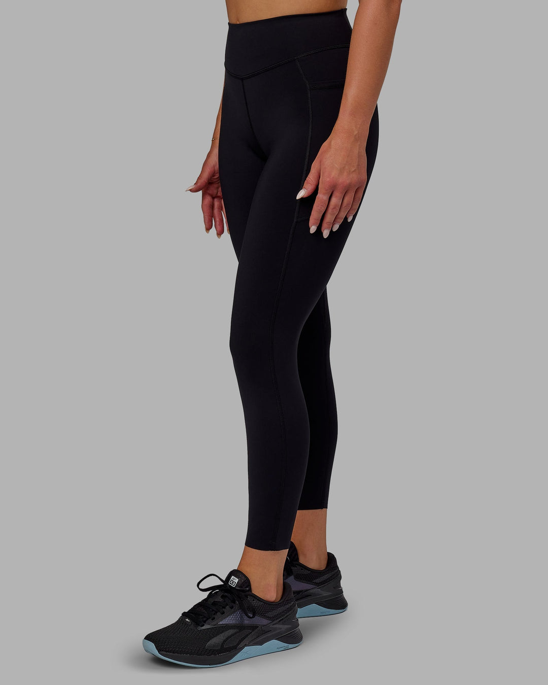 Woman wearing Elite High-Rise 7/8 Legging Pockets - Black