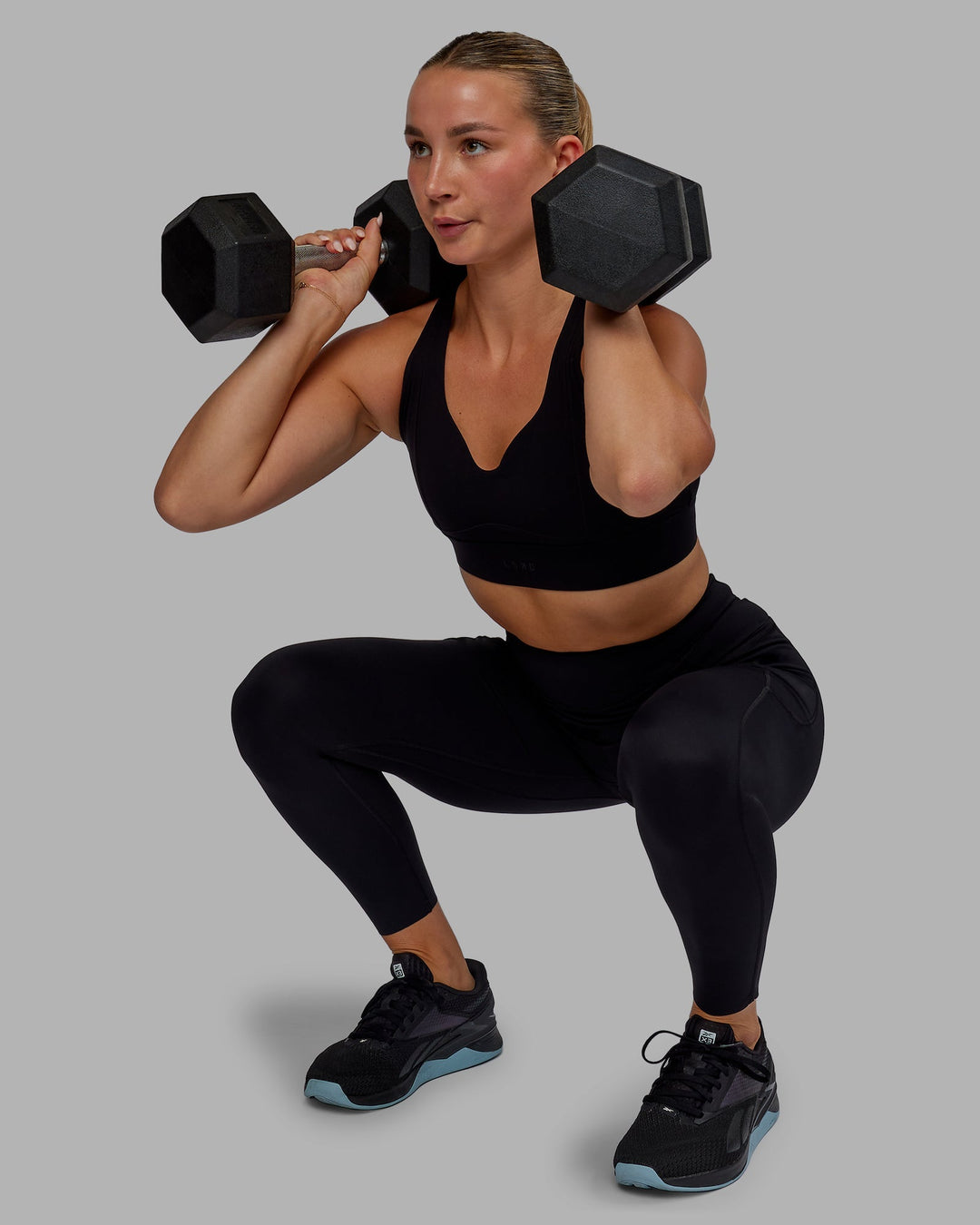 Woman wearing Elite High-Rise 7/8 Legging Pockets - Black