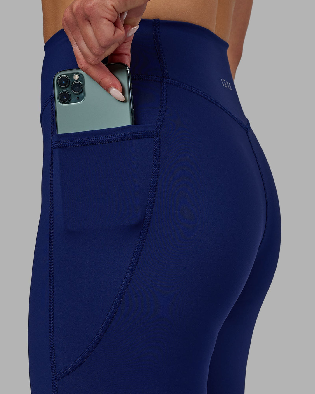 Woman wearing Elite High-Rise Full Length Legging Pockets - Midnight Blue