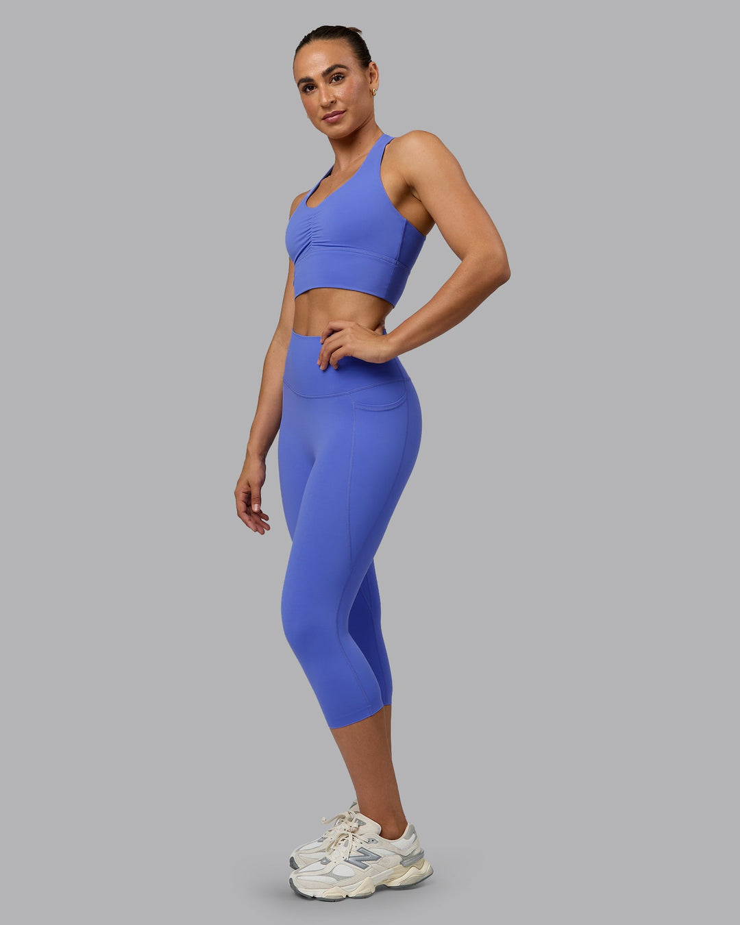 Woman wearing Elixir Ultra High-Rise 3/4 Legging Pockets - Baja Blue | Model:Sophie | Size:S