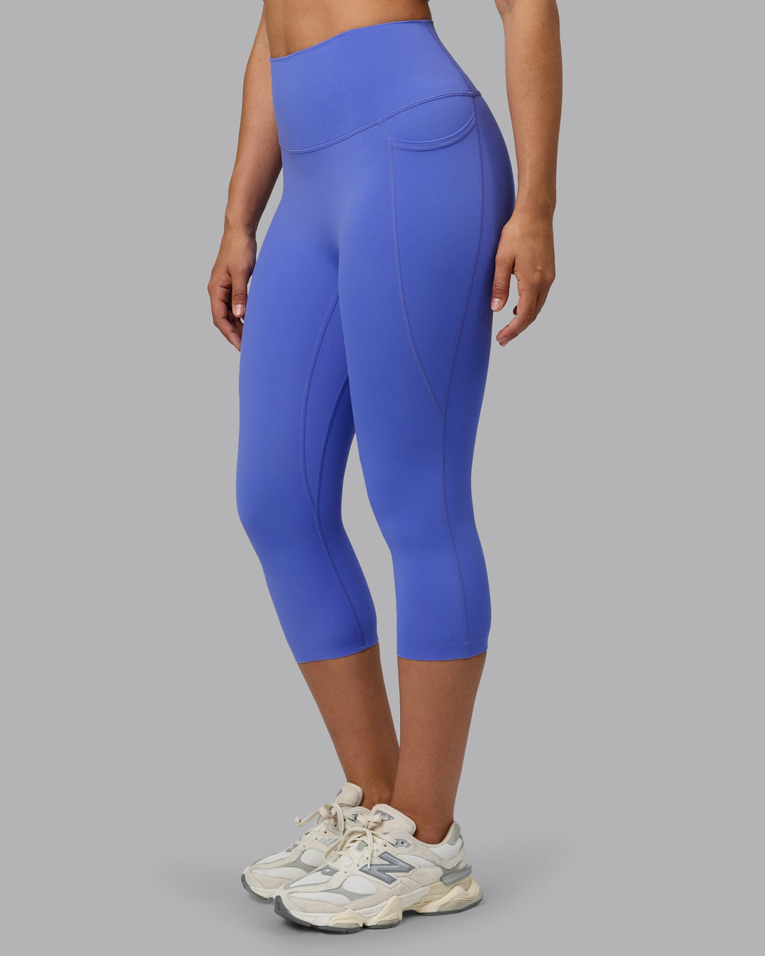 Woman wearing Elixir Ultra High-Rise 3/4 Legging Pockets - Baja Blue | Model:Sophie | Size:S
