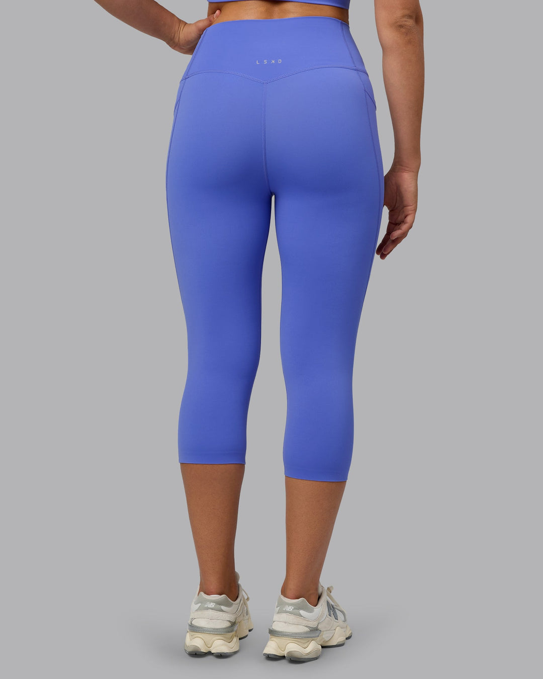 Woman wearing Elixir Ultra High-Rise 3/4 Legging Pockets - Baja Blue | Model:Sophie | Size:S