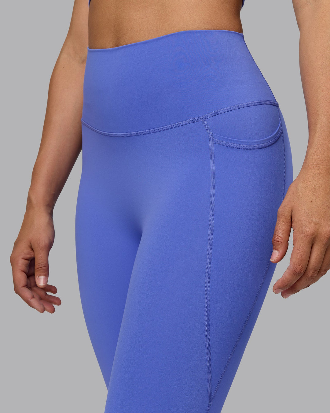 Woman wearing Elixir Ultra High-Rise 3/4 Legging Pockets - Baja Blue | Model:Sophie | Size:S