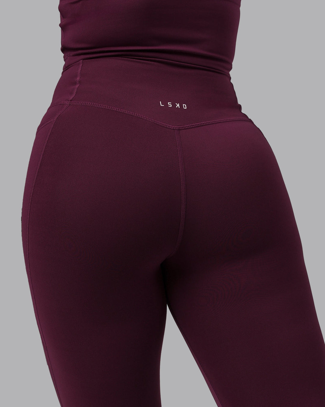 Woman wearing Elixir Ultra High-Rise 7/8 Legging Pockets - Cherry Lacquer