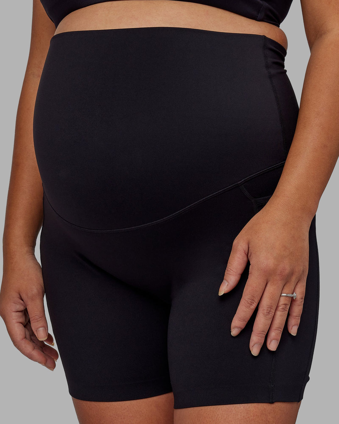 Woman wearing Elixir Ultra High-Rise Maternity 6" Short Pockets - Black | Model:Jojo | Size:M