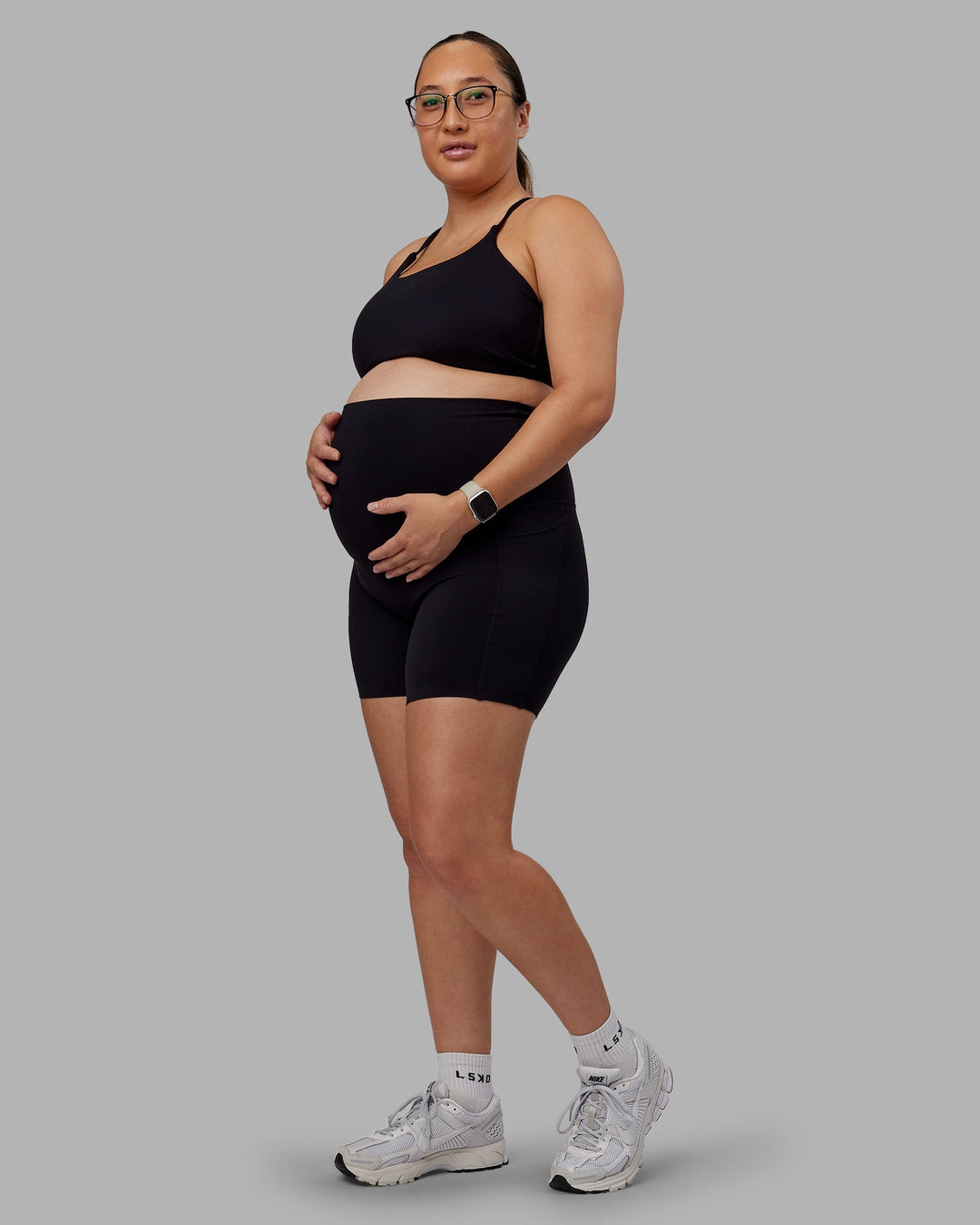 Woman wearing Elixir Ultra High-Rise Maternity 6" Short Pockets - Black | Model:Nevada | Size:M