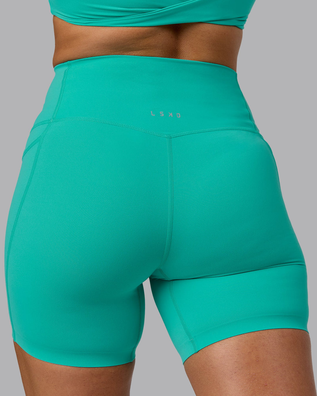 Woman wearing Elixir Ultra High-Rise 6" Short Pockets - Atlantis