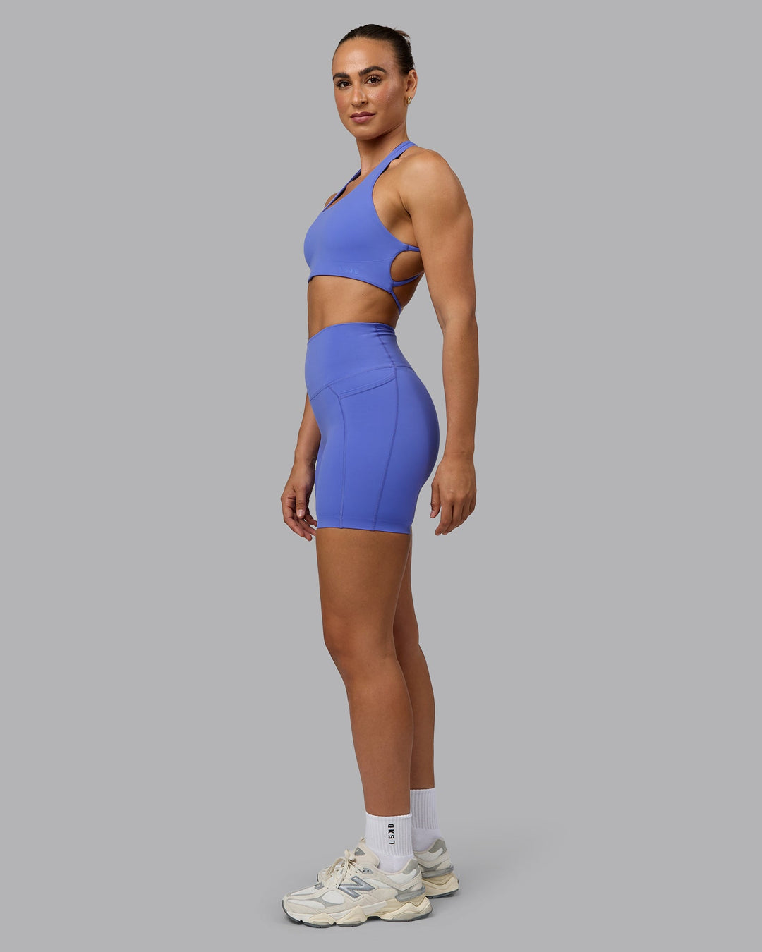 Woman wearing Elixir Ultra High-Rise 6" Short Pockets - Baja Blue