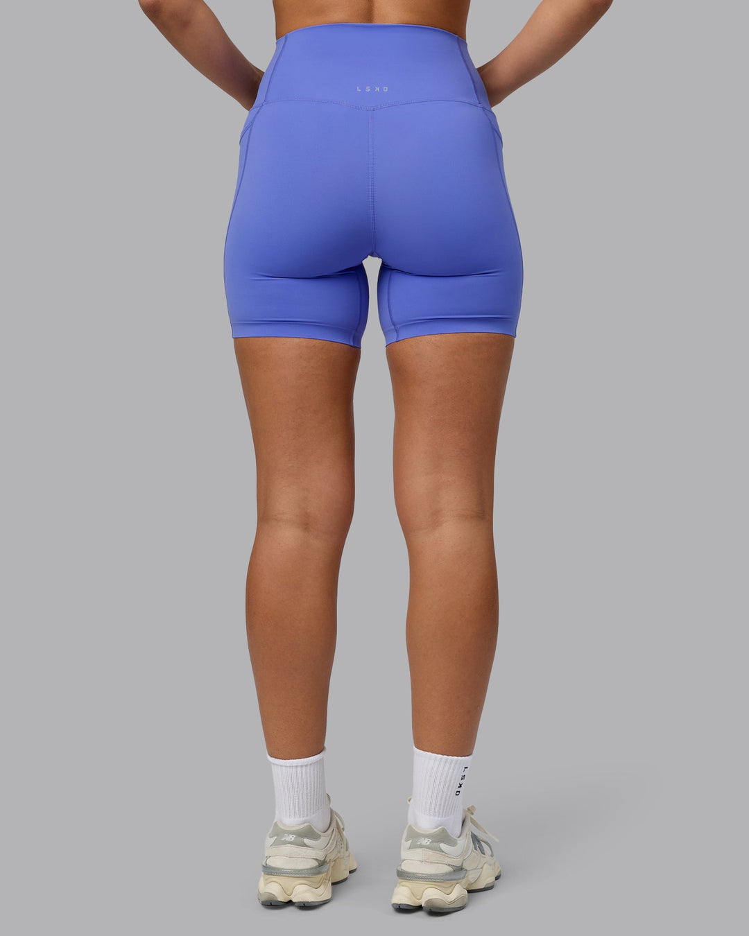 Woman wearing Elixir Ultra High-Rise 6" Short Pockets - Baja Blue
