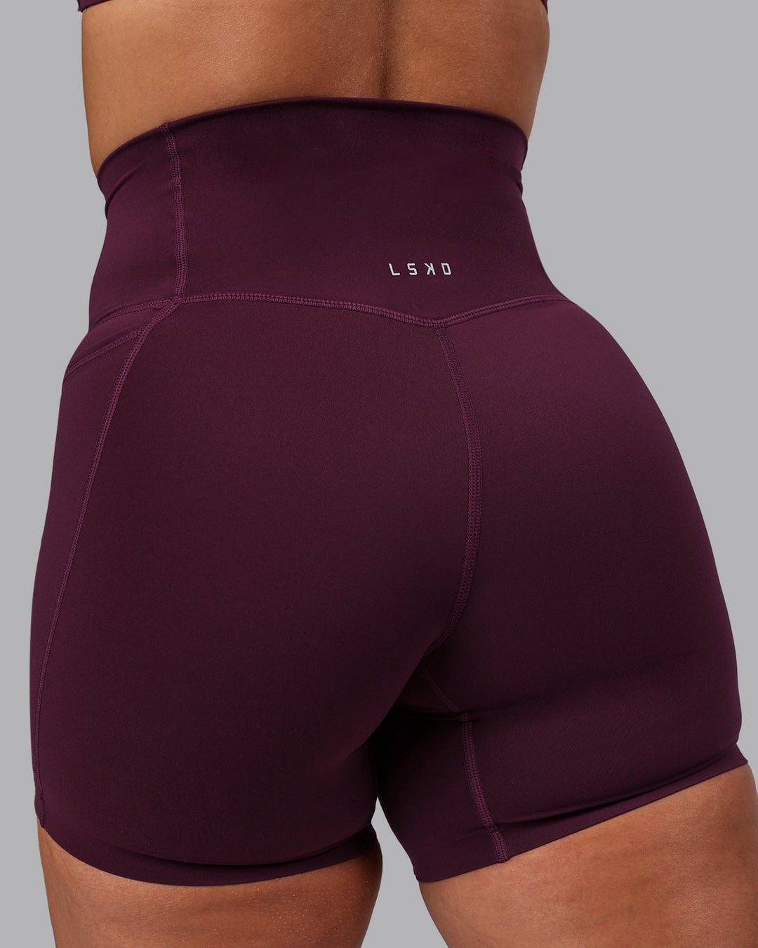 Woman wearing Elixir Ultra High-Rise 6" Short Pockets - Cherry Lacquer