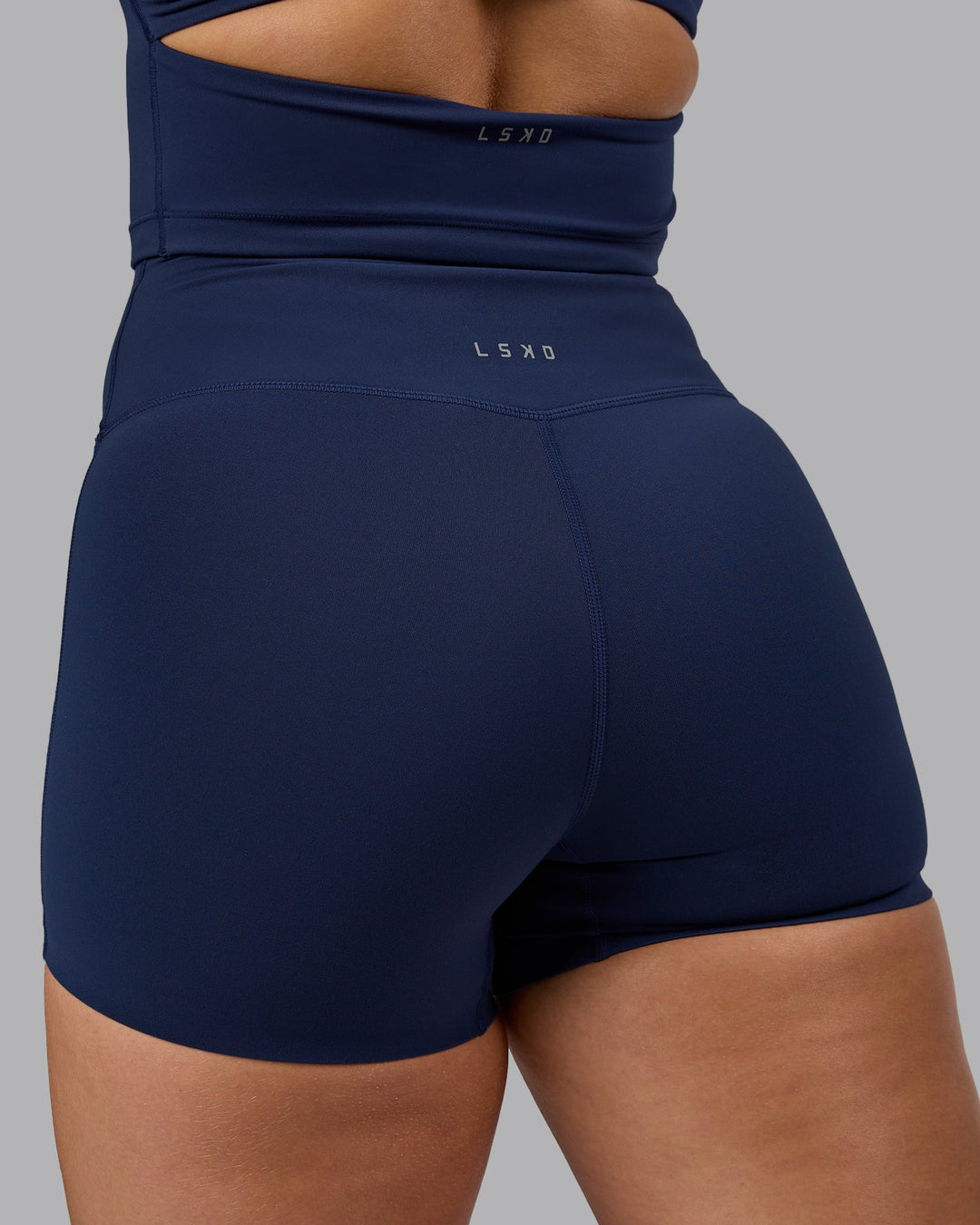 Woman wearing Elixir Ultra High-Rise 4" Short - Future Navy