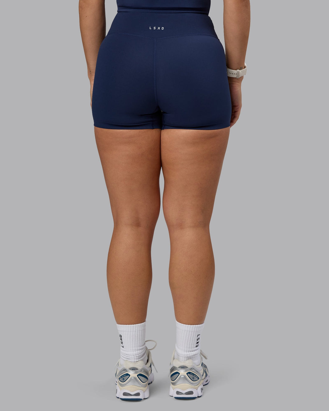 Woman wearing Elixir Ultra High-Rise 4" Short - Future Navy