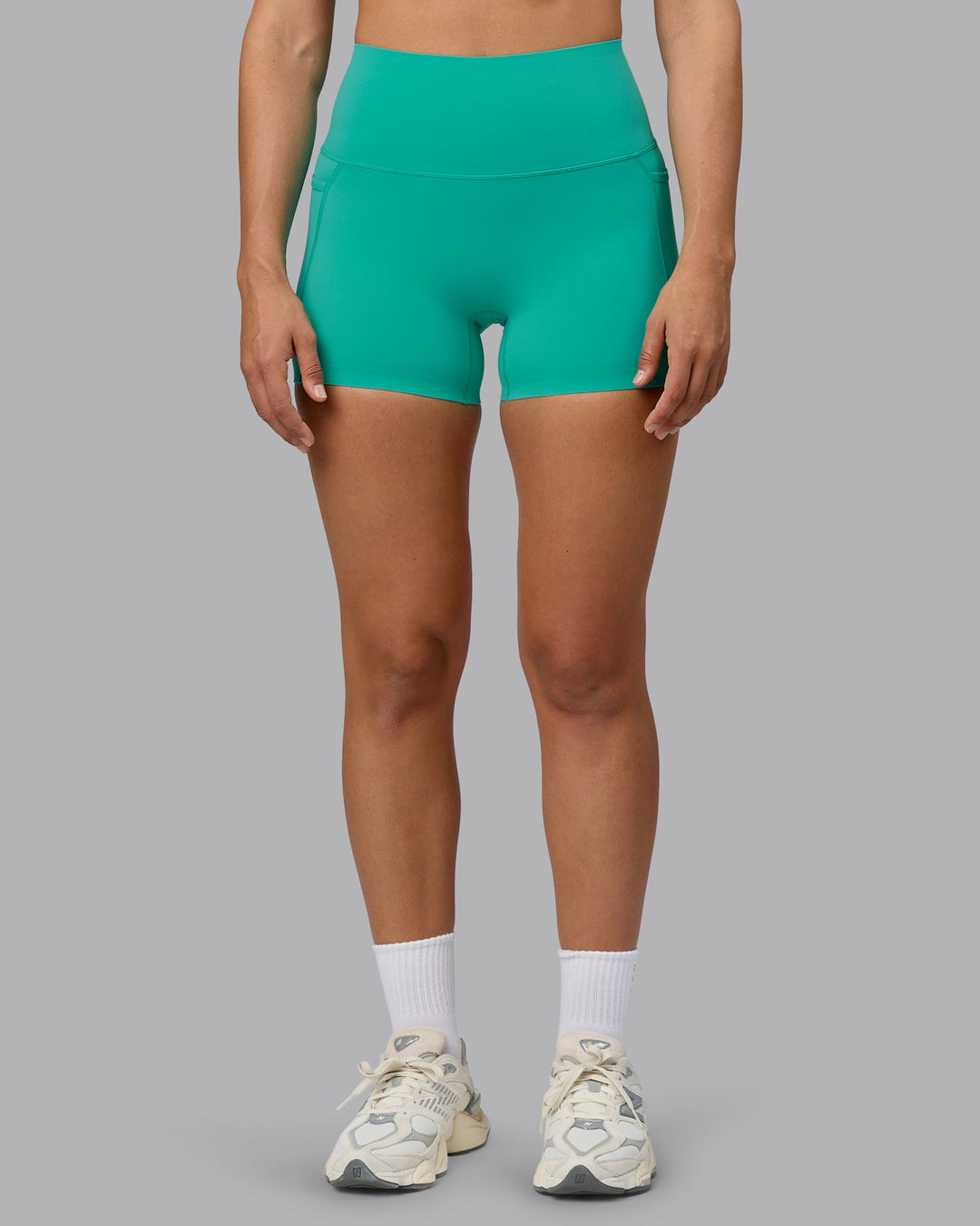 Woman wearing Elixir Ultra High-Rise 4" Short Pockets - Atlantis