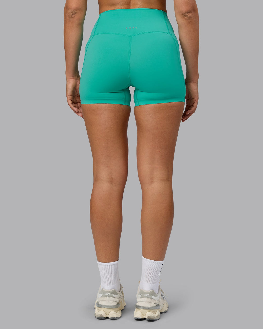 Woman wearing Elixir Ultra High-Rise 4" Short Pockets - Atlantis