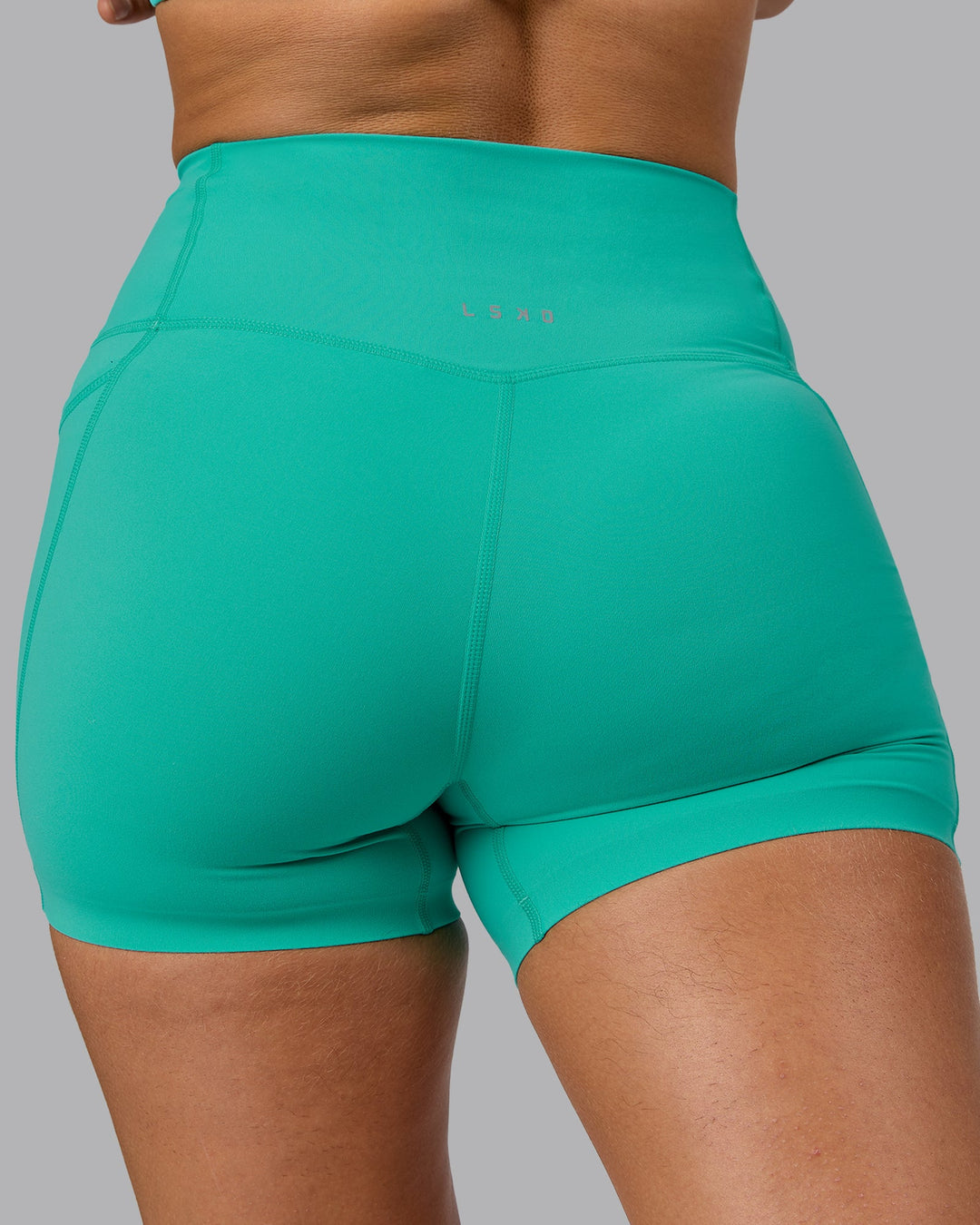 Woman wearing Elixir Ultra High-Rise 4" Short Pockets - Atlantis