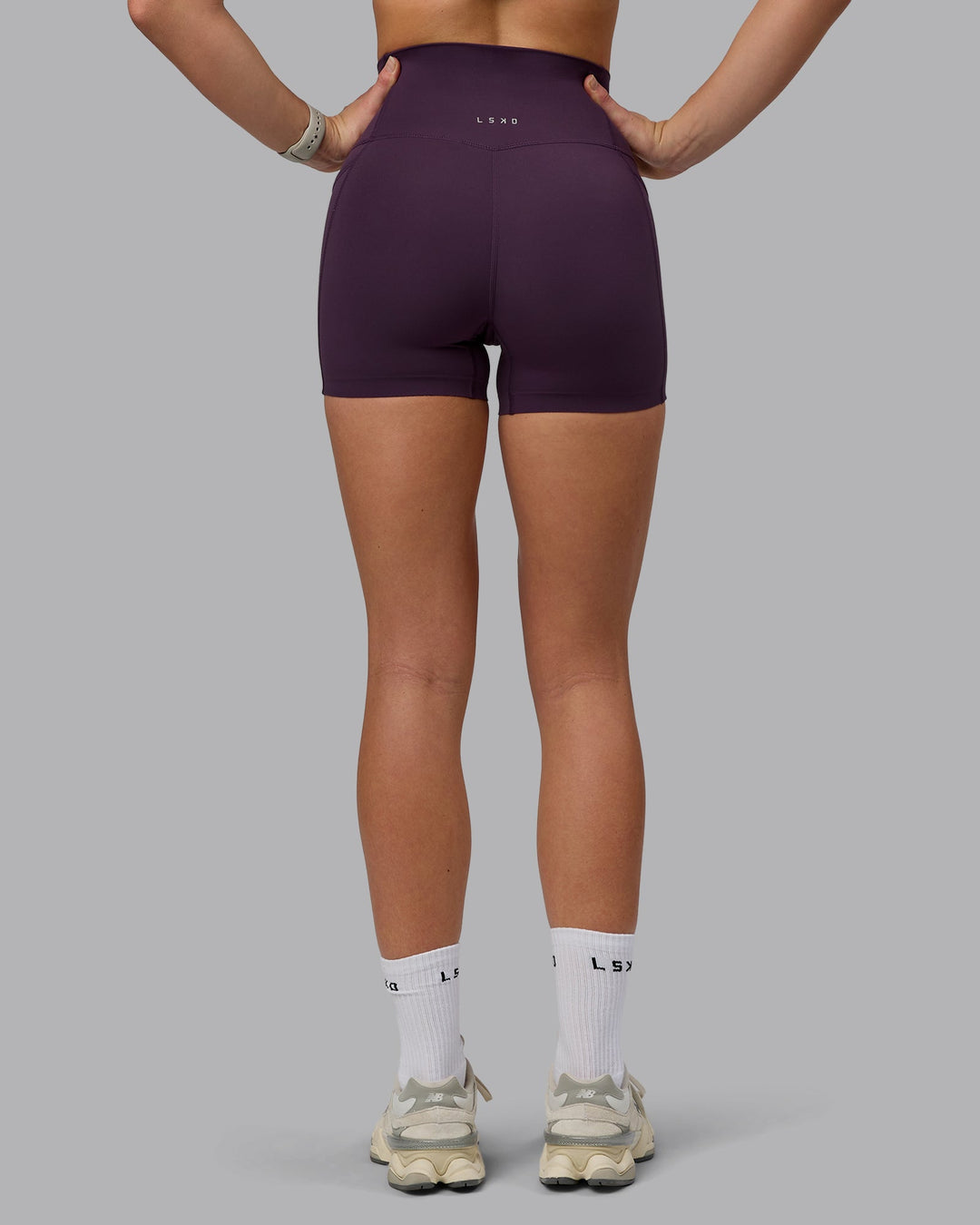 Woman wearing Elixir Ultra High-Rise 4" Short Pockets - Midnight Plum