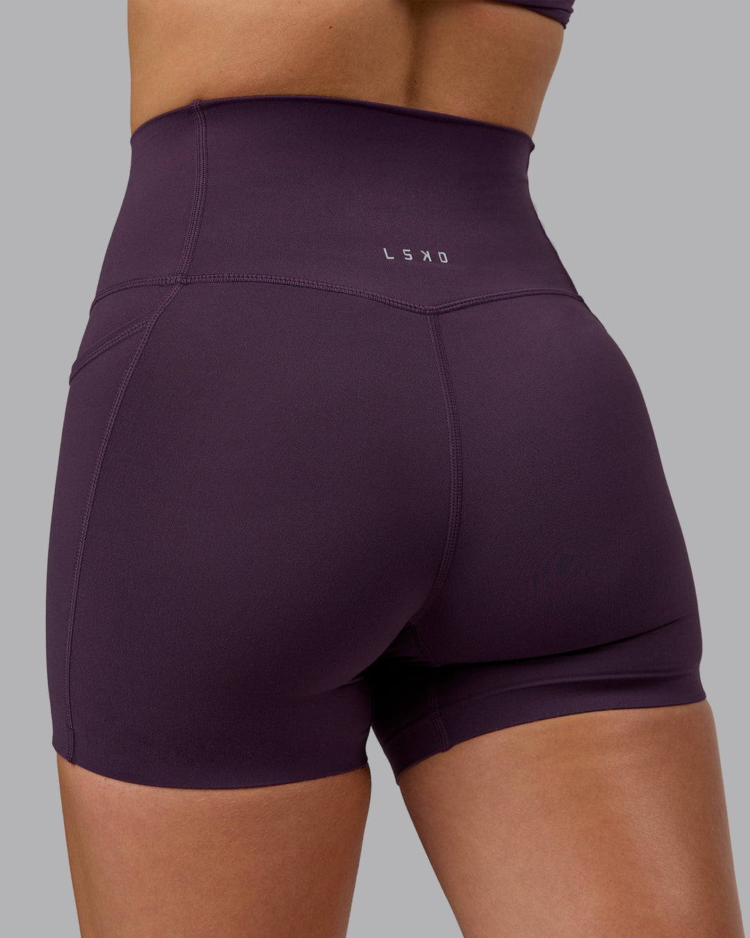 Woman wearing Elixir Ultra High-Rise 4" Short Pockets - Midnight Plum