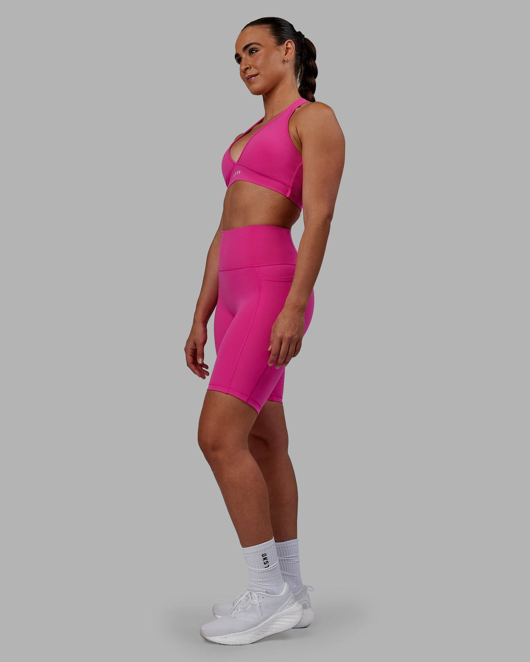 Woman wearing Fusion Ultra High-Rise 9" Short Pockets - Fuchsia Pink | Model:Sophie | Size:S