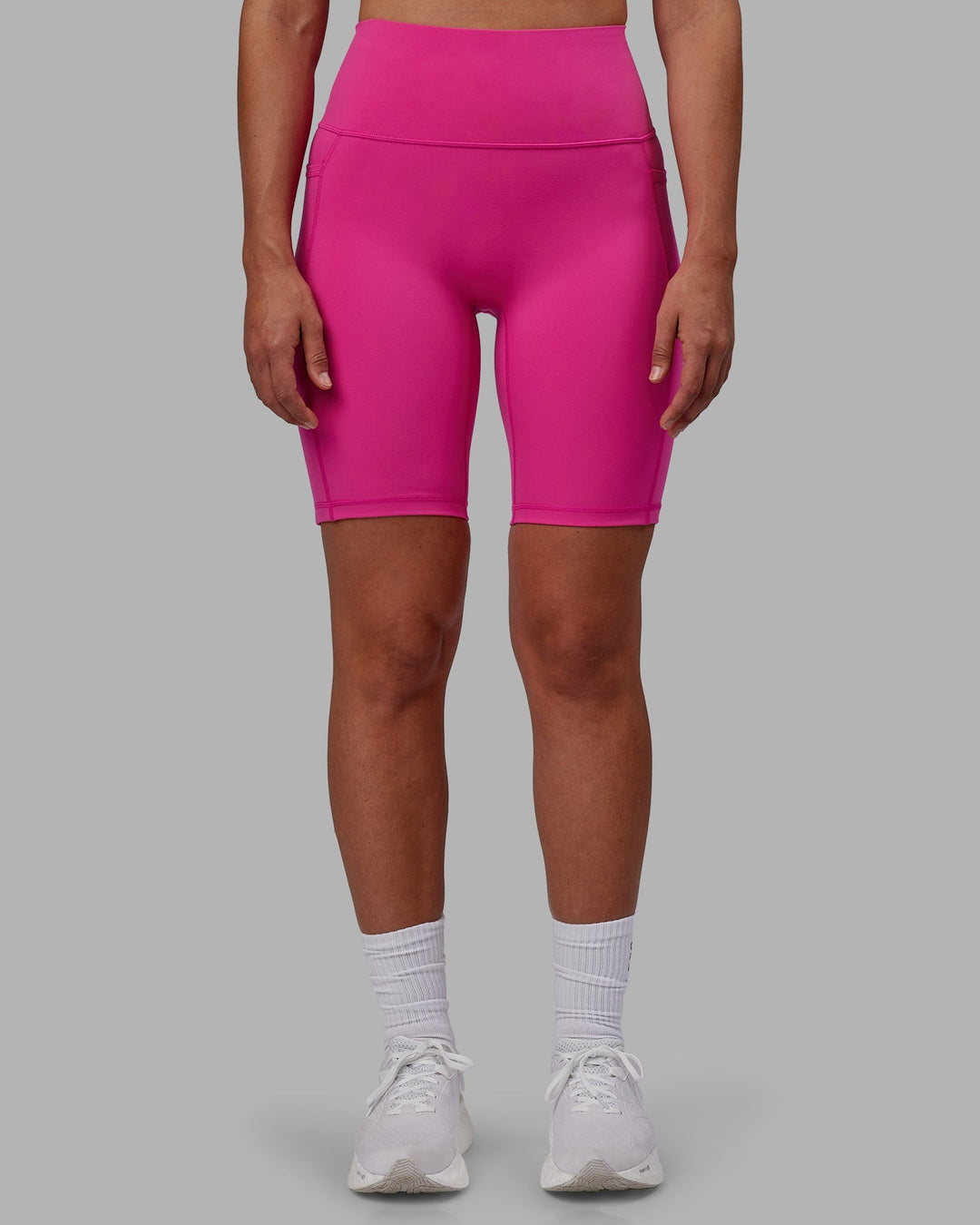 Woman wearing Fusion Ultra High-Rise 9" Short Pockets - Fuchsia Pink | Model:Sophie | Size:S