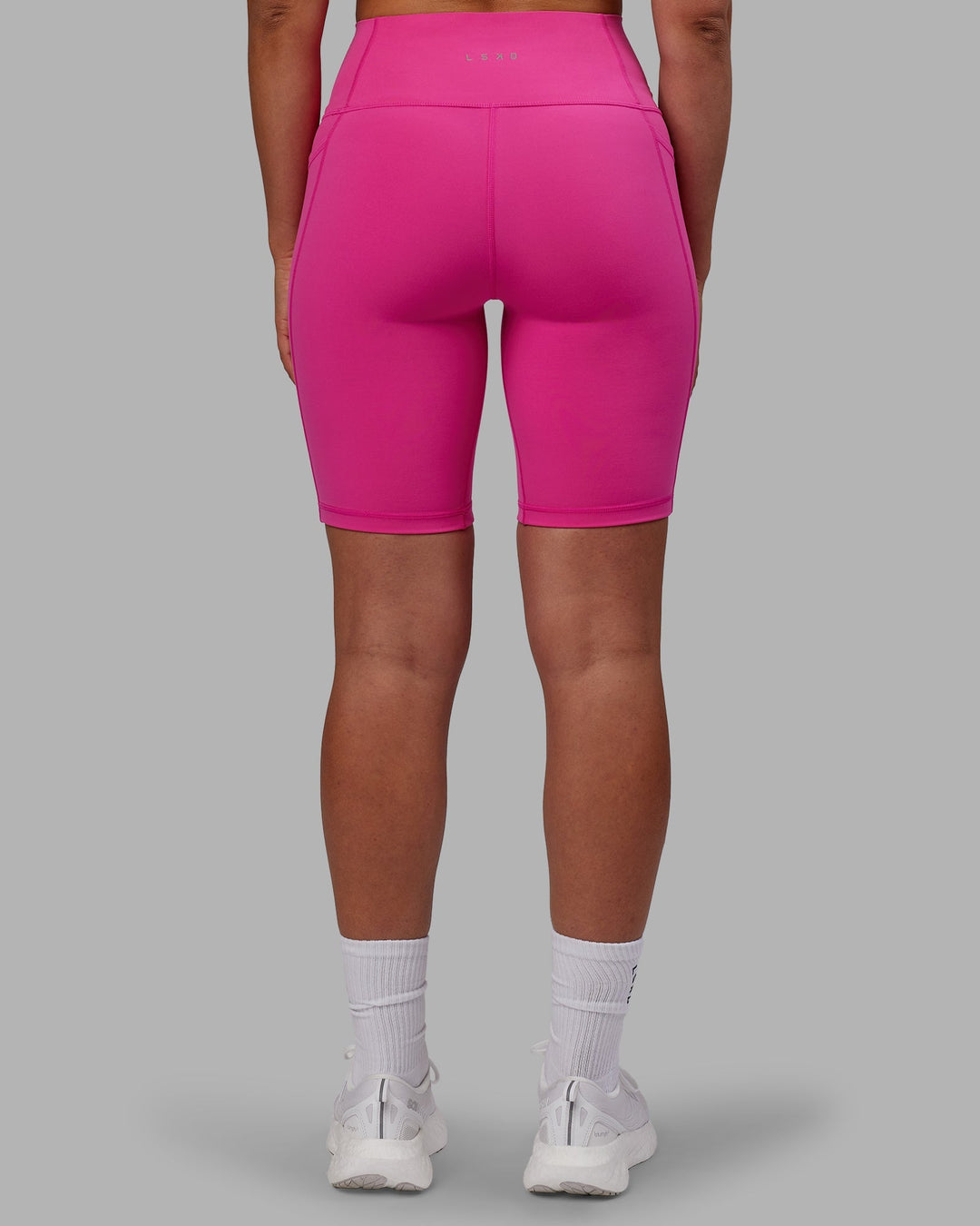 Woman wearing Fusion Ultra High-Rise 9" Short Pockets - Fuchsia Pink | Model:Sophie | Size:S