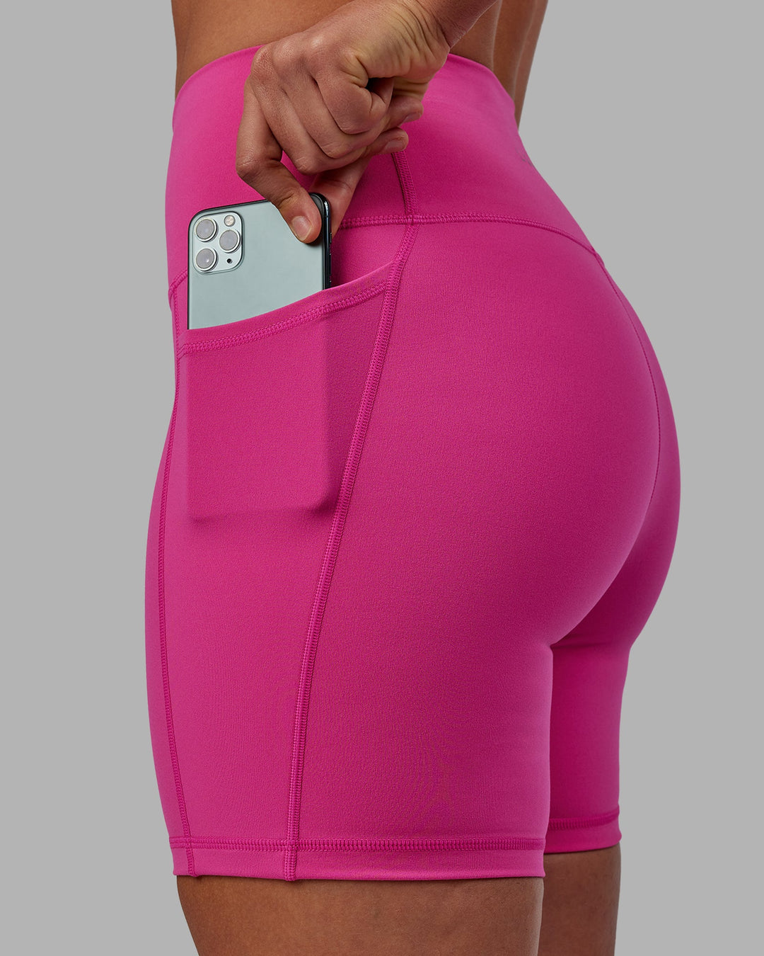 Woman wearing Fusion Ultra High-Rise 6" Short Pockets - Fuchsia Pink | Model:Sophie | Size:S