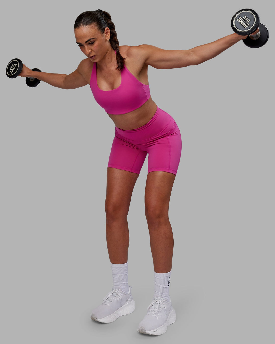 Woman wearing Fusion Ultra High-Rise 6" Short Pockets - Fuchsia Pink | Model:Sophie | Size:S