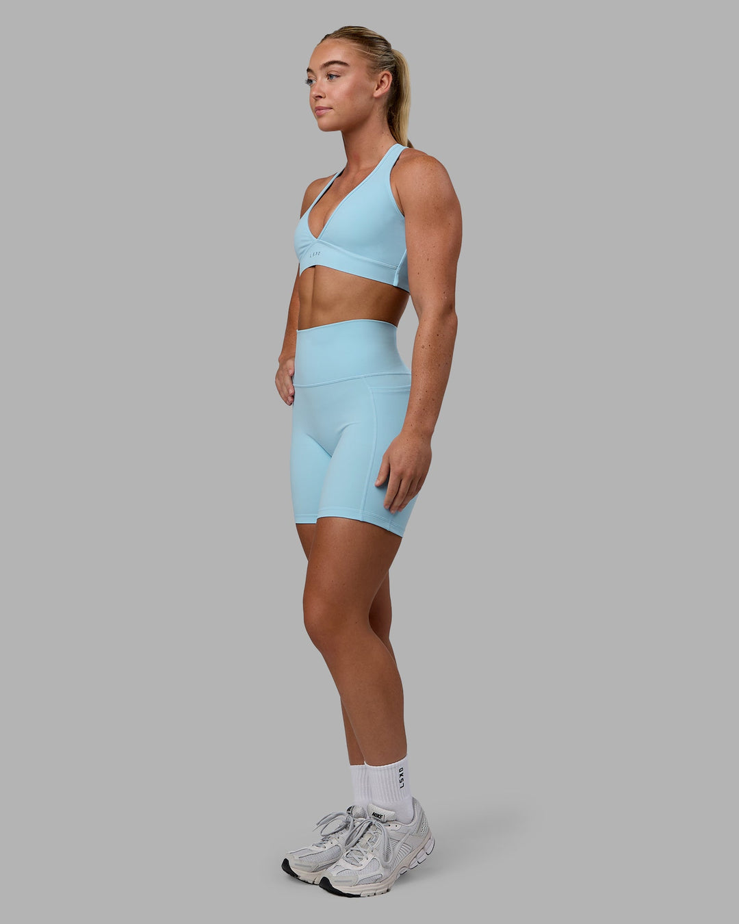 Woman wearing Fusion Ultra High-Rise 6" Short Pockets - Glacial Blue | Model:Monique | Size:S