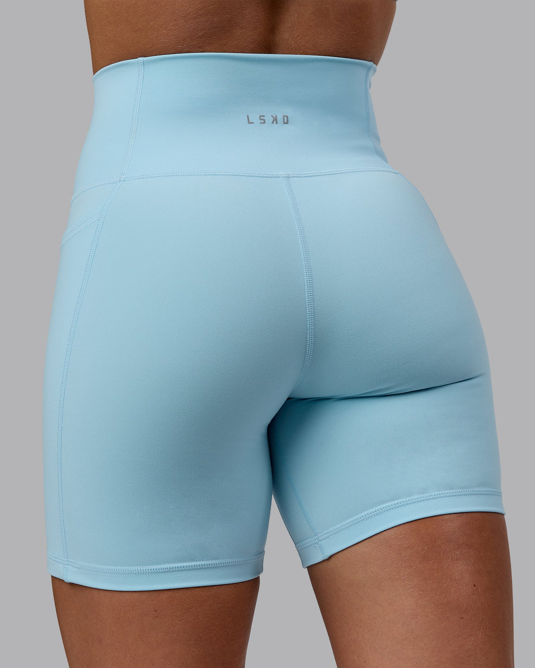Woman wearing Fusion Ultra High-Rise 6" Short Pockets - Glacial Blue | Model:Monique | Size:S
