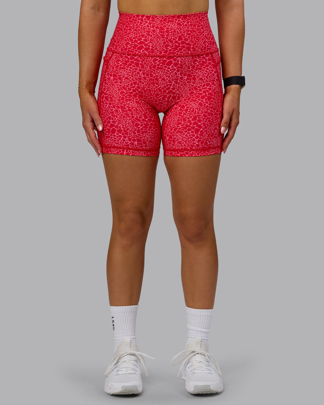 Woman wearing Fusion Ultra High-Rise 6" Short Pockets - Red Vitality Print | Model:Halle | Size:S