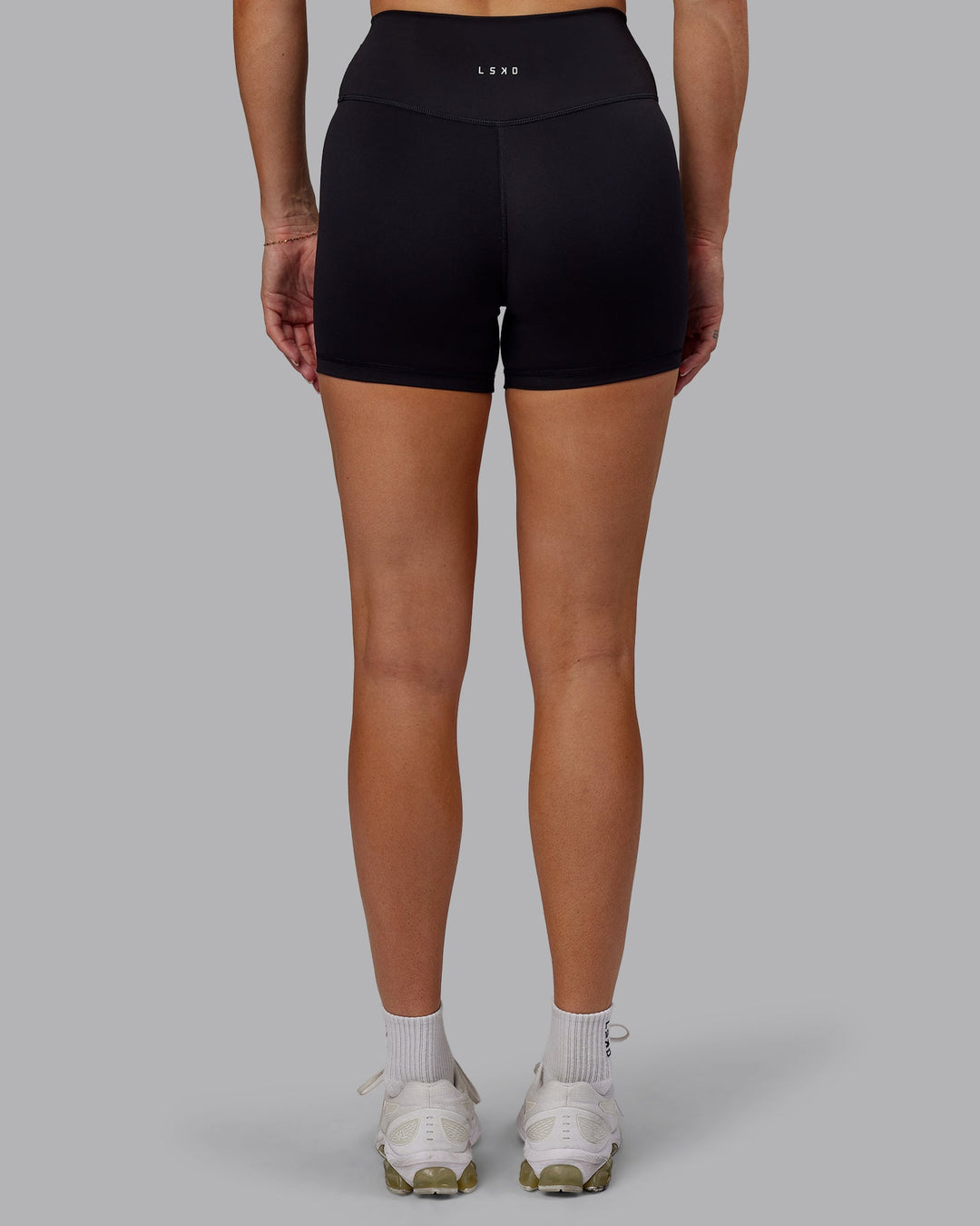 Woman wearing Fusion Ultra High-Rise 4" Short - Black | Model:Hannah | Size:S
