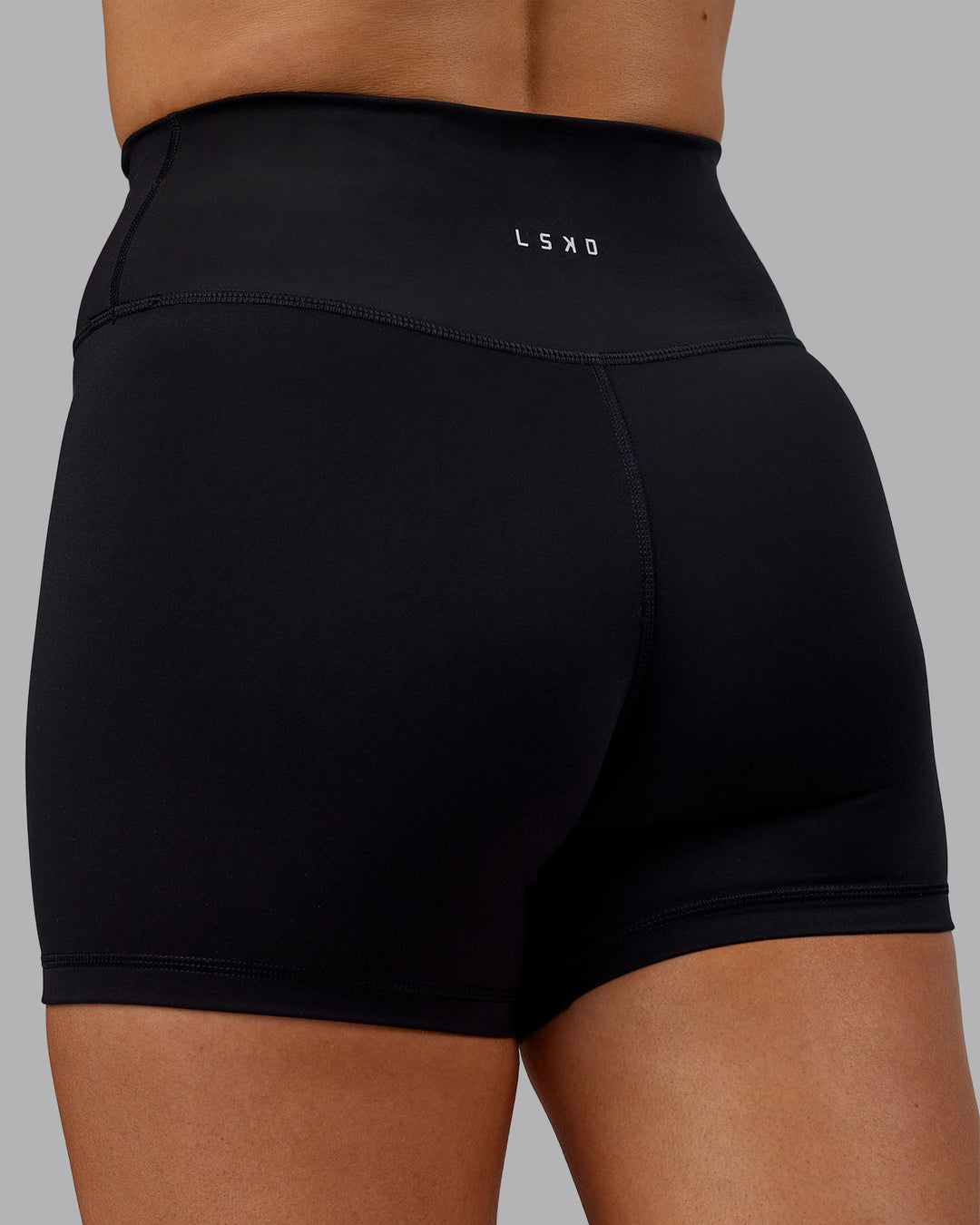 Woman wearing Fusion Ultra High-Rise 4" Short - Black | Model:Hannah | Size:S