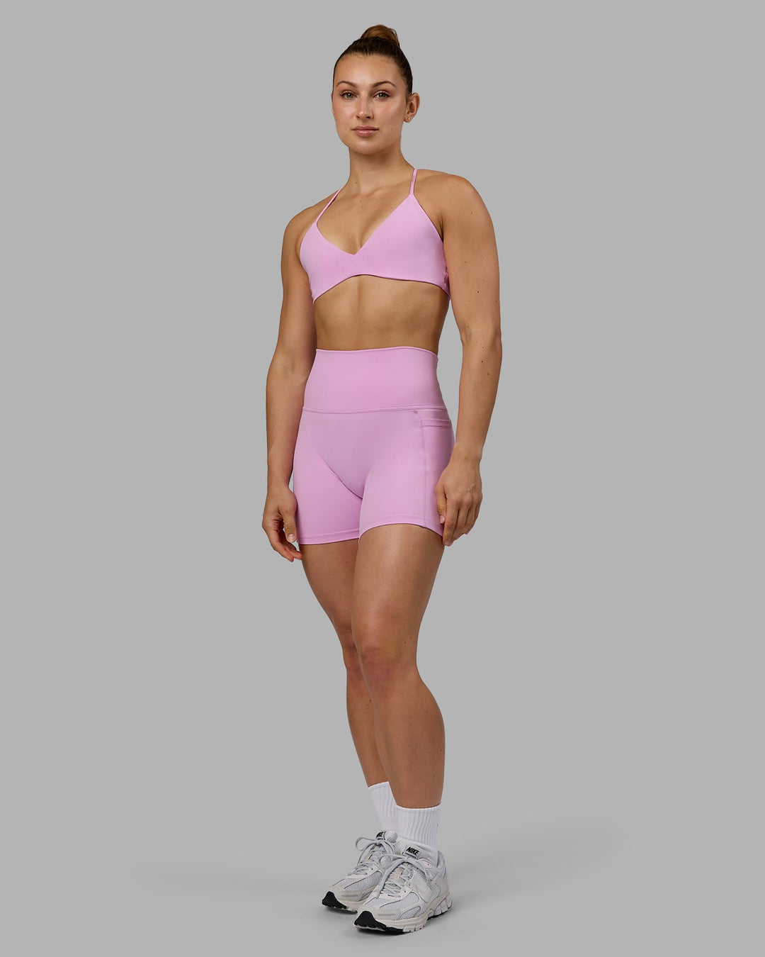 Woman wearing Fusion Ultra High-Rise 4" Short Pockets - Pastel Orchid | Model:Zoe | Size:S