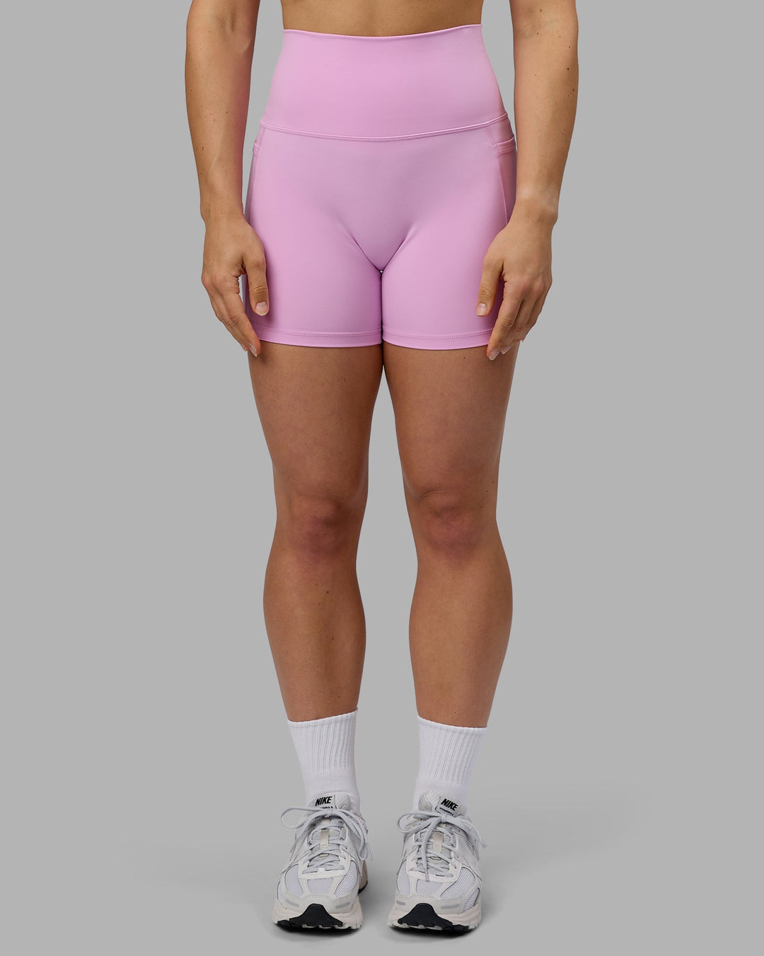 Woman wearing Fusion Ultra High-Rise 4" Short Pockets - Pastel Orchid | Model:Zoe | Size:S