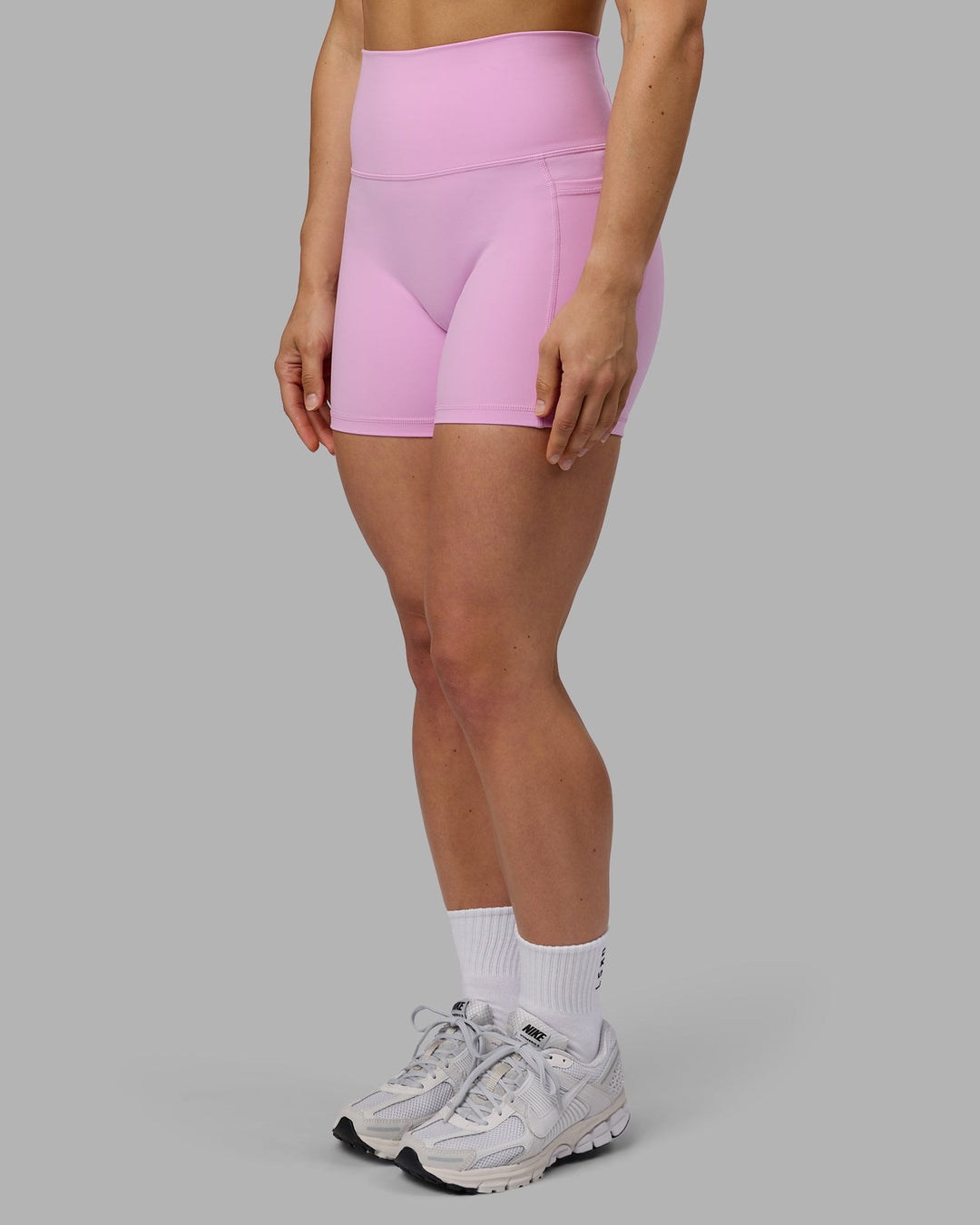 Woman wearing Fusion Ultra High-Rise 4" Short Pockets - Pastel Orchid | Model:Zoe | Size:S