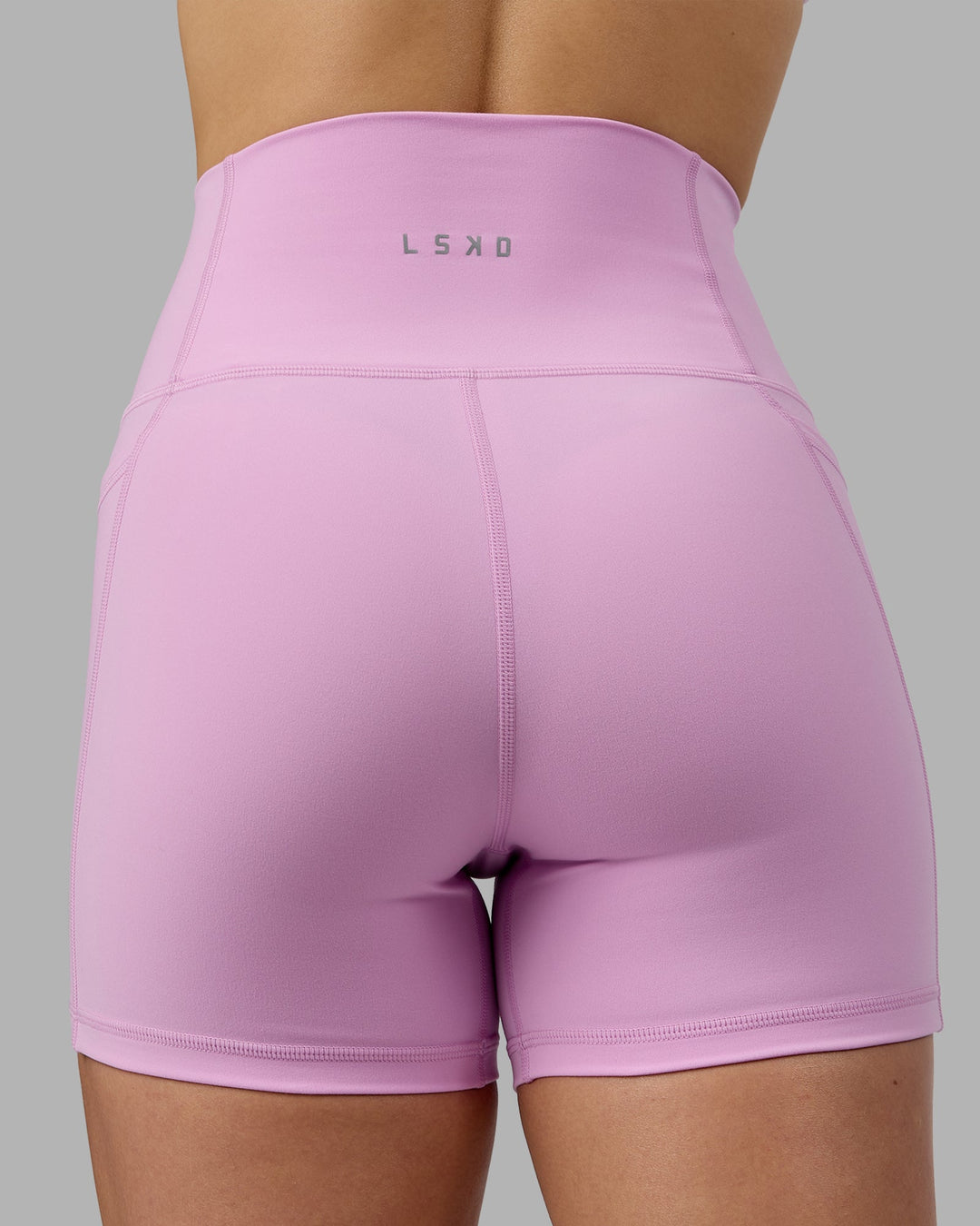 Woman wearing Fusion Ultra High-Rise 4" Short Pockets - Pastel Orchid | Model:Zoe | Size:S
