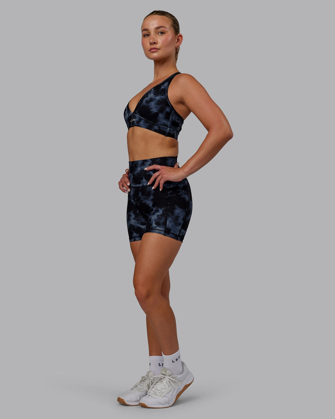 Woman wearing Fusion Ultra High-Rise 4" Short Pockets - Tie Dye-Midnight | Model:Halle | Size:S