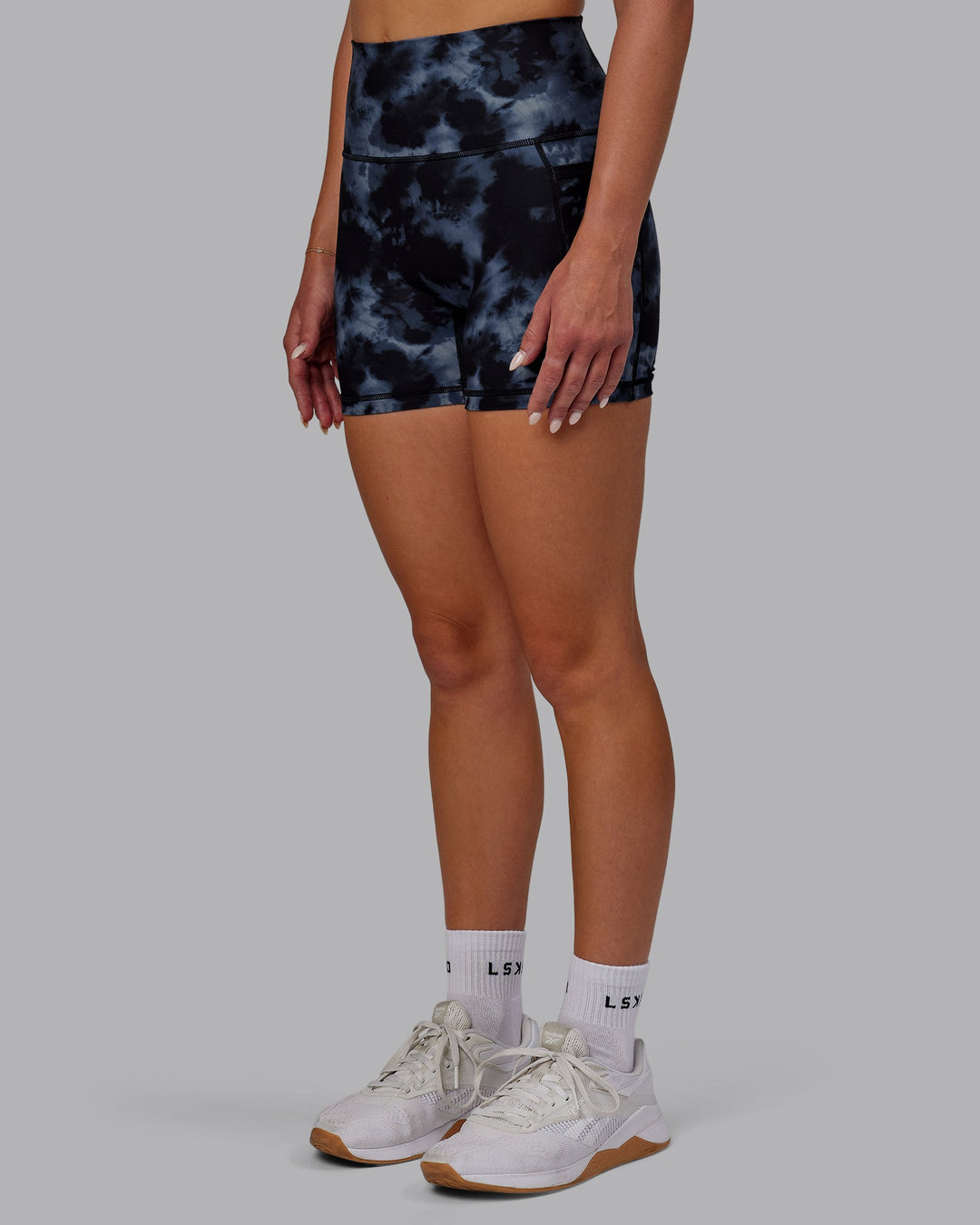 Woman wearing Fusion Ultra High-Rise 4" Short Pockets - Tie Dye-Midnight | Model:Halle | Size:S
