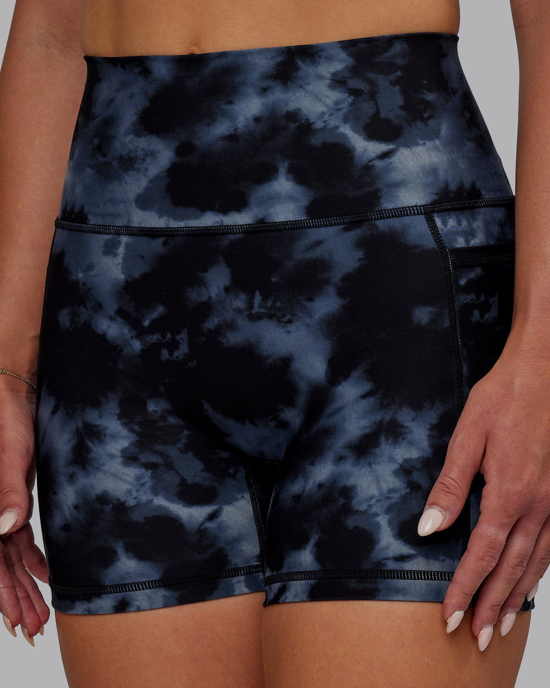 Woman wearing Fusion Ultra High-Rise 4" Short Pockets - Tie Dye-Midnight | Model:Suz | Size:S