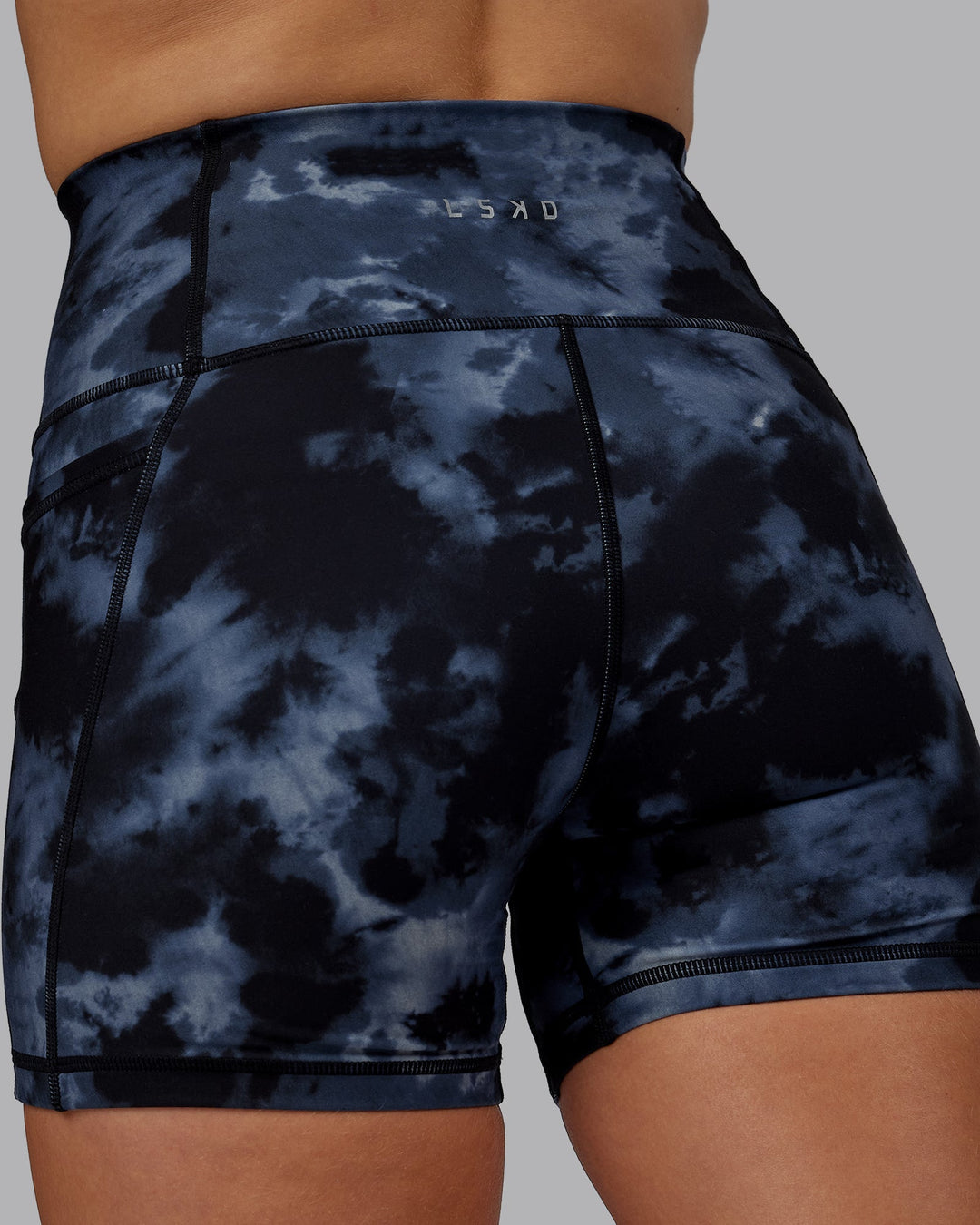 Woman wearing Fusion Ultra High-Rise 4" Short Pockets - Tie Dye-Midnight | Model:Halle | Size:S