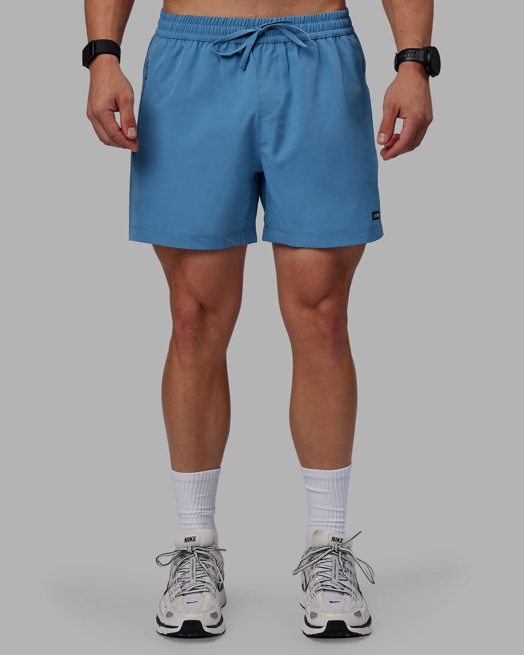 Man wearing Rep 5" Performance Shorts - Elemental Blue