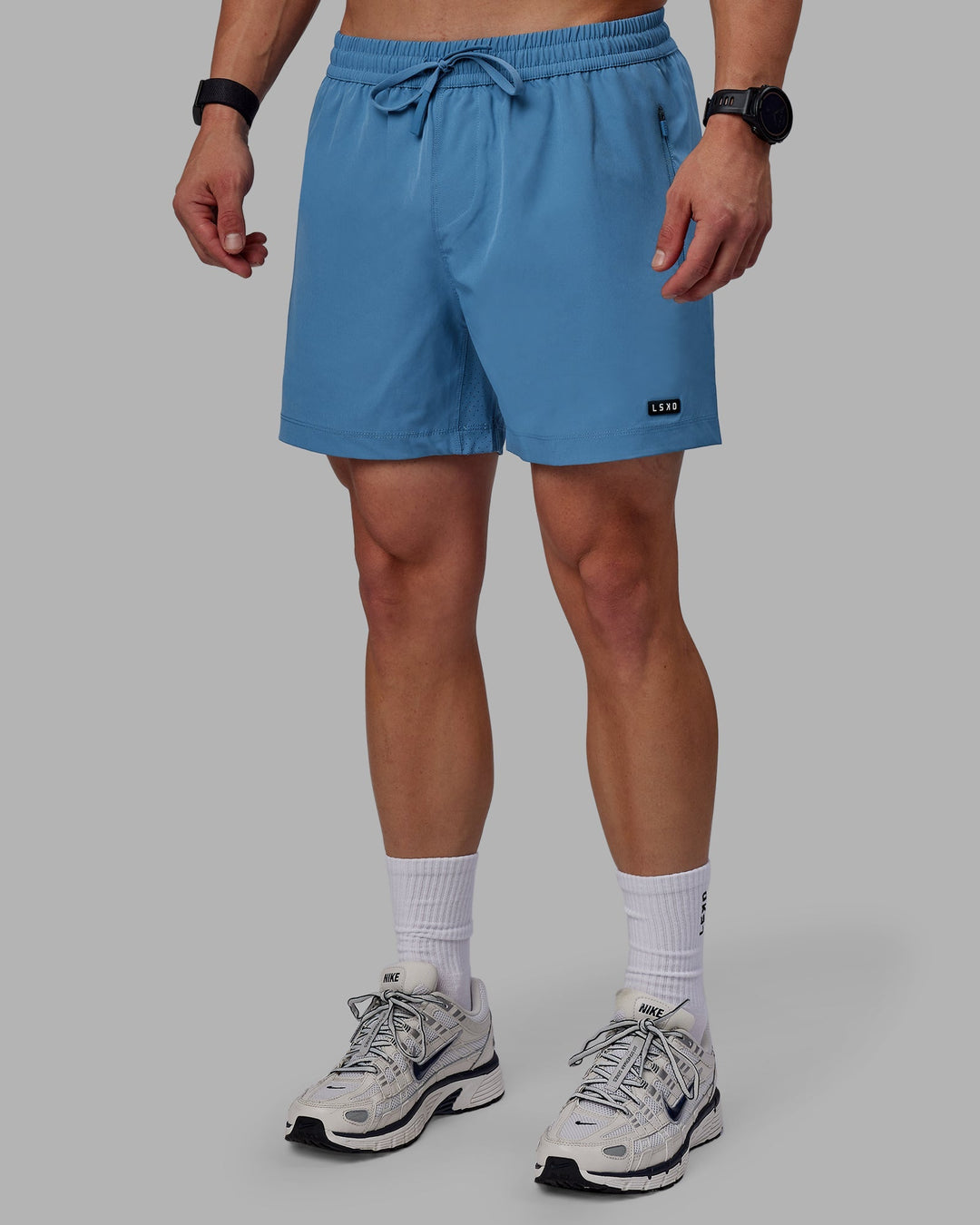 Man wearing Rep 5" Performance Shorts - Elemental Blue