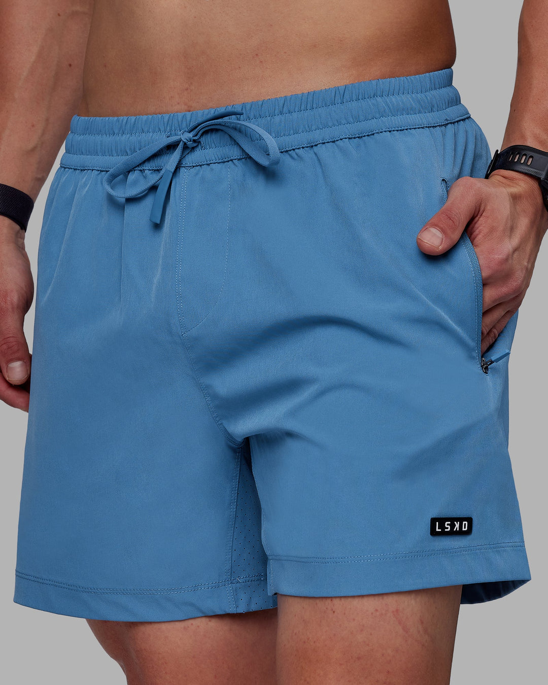 Man wearing Rep 5" Performance Shorts - Elemental Blue