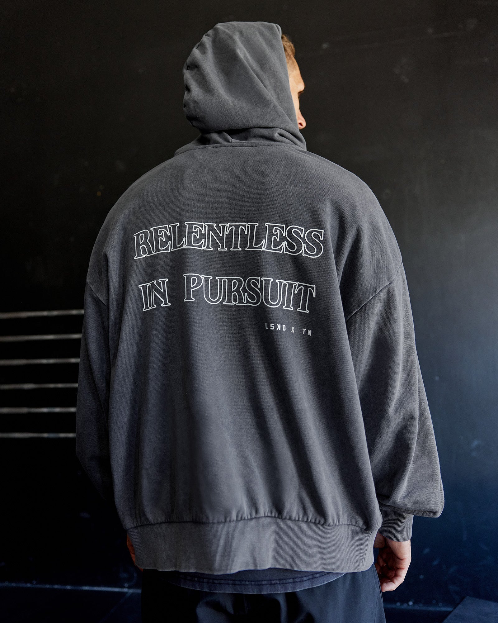 Man wearing Relentless Washed Zip Through Oversized Hoodie - Dark Storm-White | Model:Tommy | Size:S