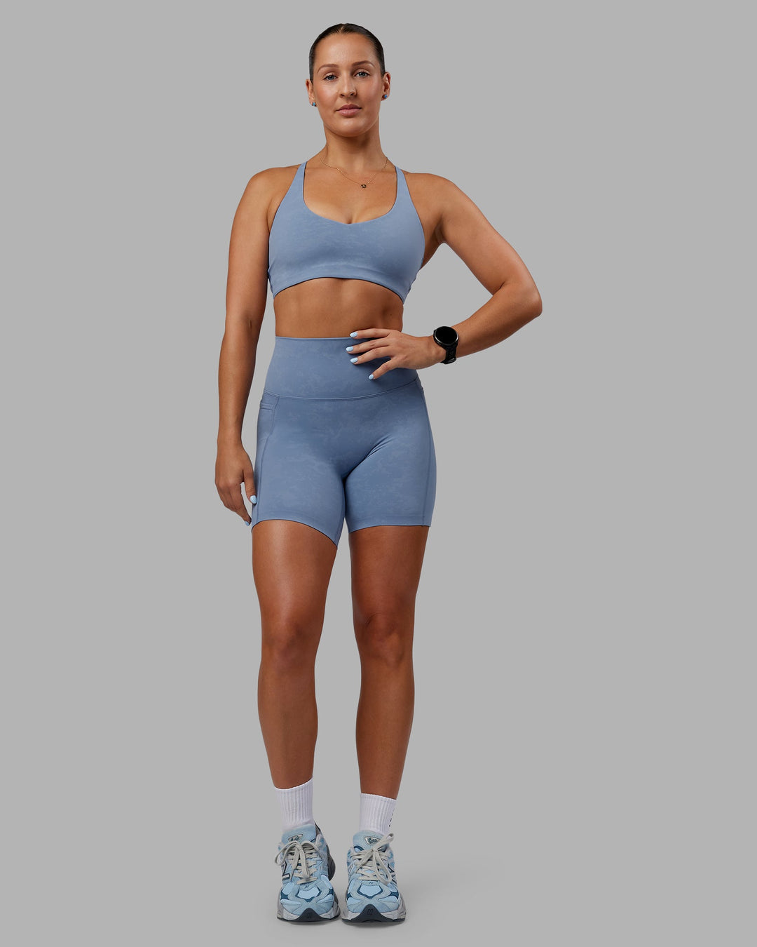 Woman wearing Abs Elixir Ultra High-Rise 6" Short Pockets - Infinity Mirage