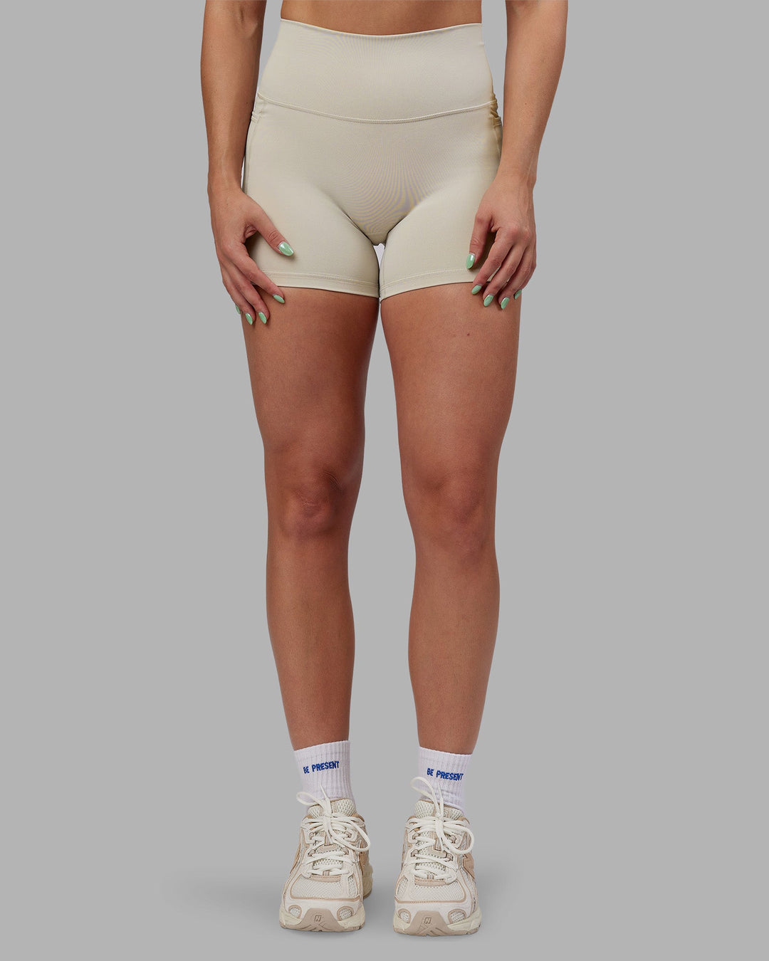 Woman wearing Abs Fusion High-Rise 4" Short Pockets - Shale Beige | Model:Abbey | Size:S