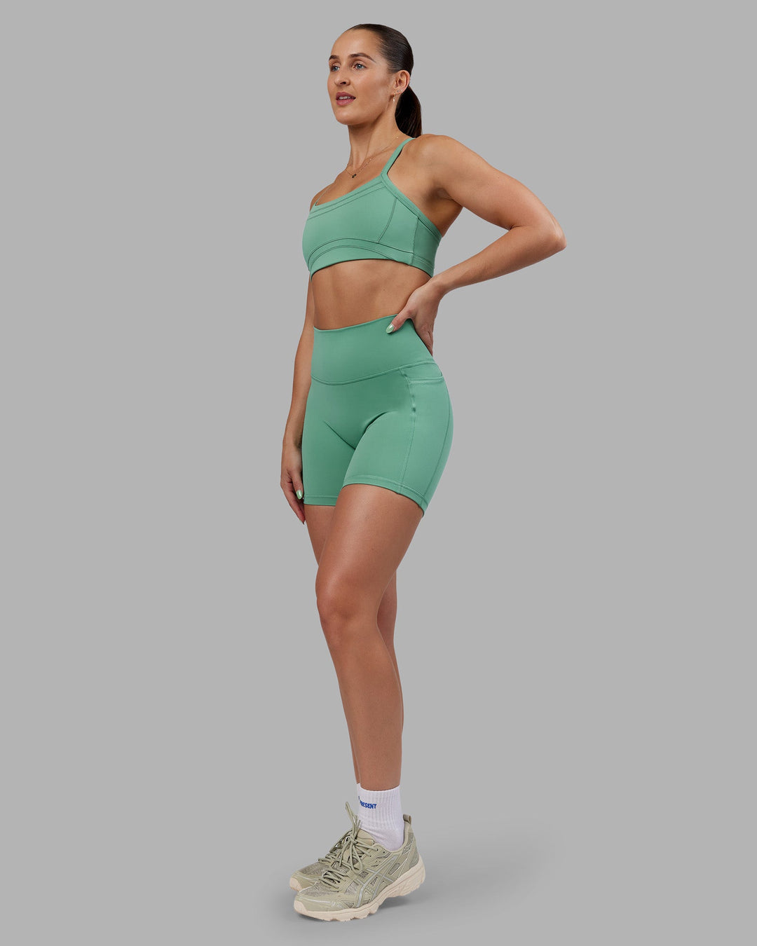 Woman wearing Abs Fusion High-Rise 6" Short Pockets - Matcha Green | Model:Abbey | Size:S