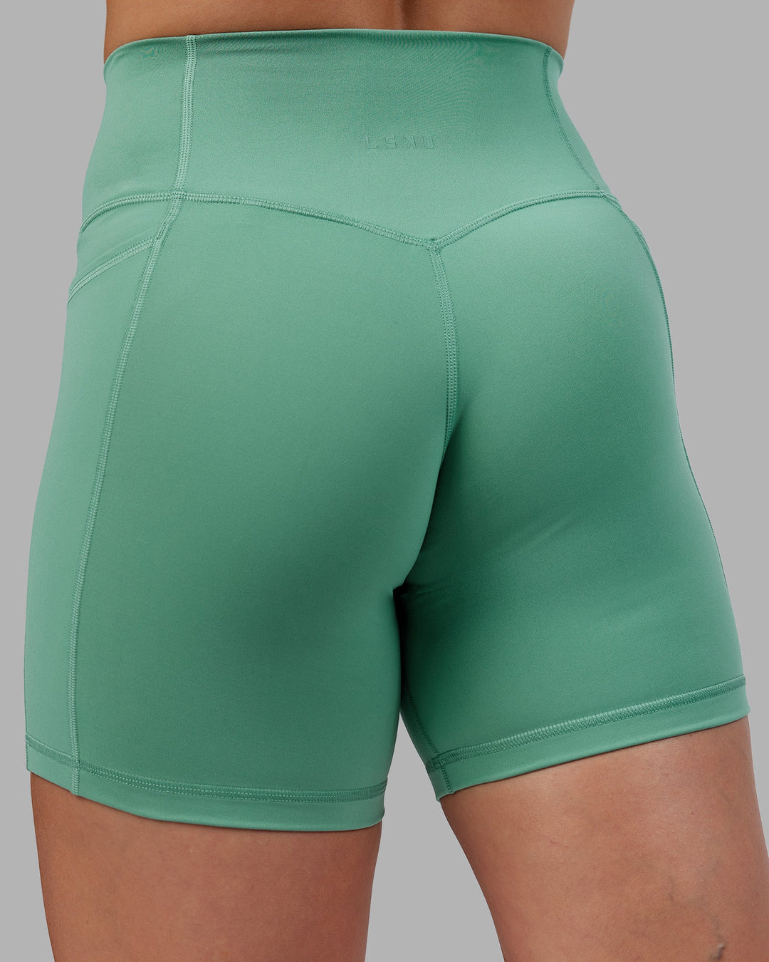 Woman wearing Abs Fusion High-Rise 6" Short Pockets - Matcha Green | Model:Abbey | Size:S