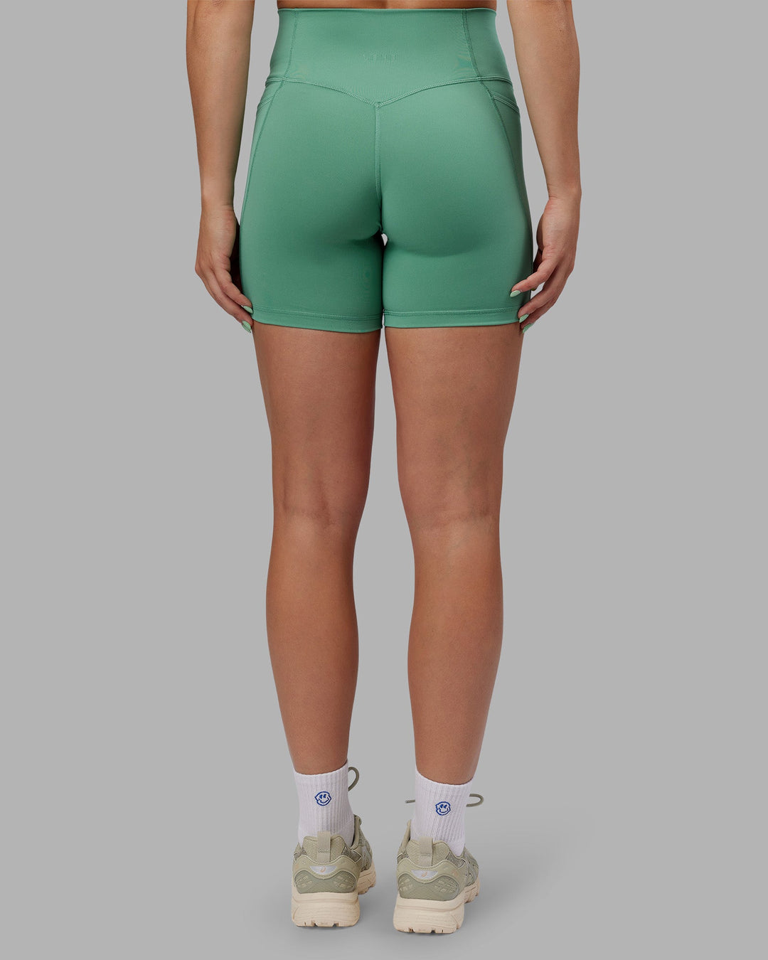 Woman wearing Abs Fusion High-Rise 6" Short Pockets - Matcha Green | Model:Abbey | Size:S