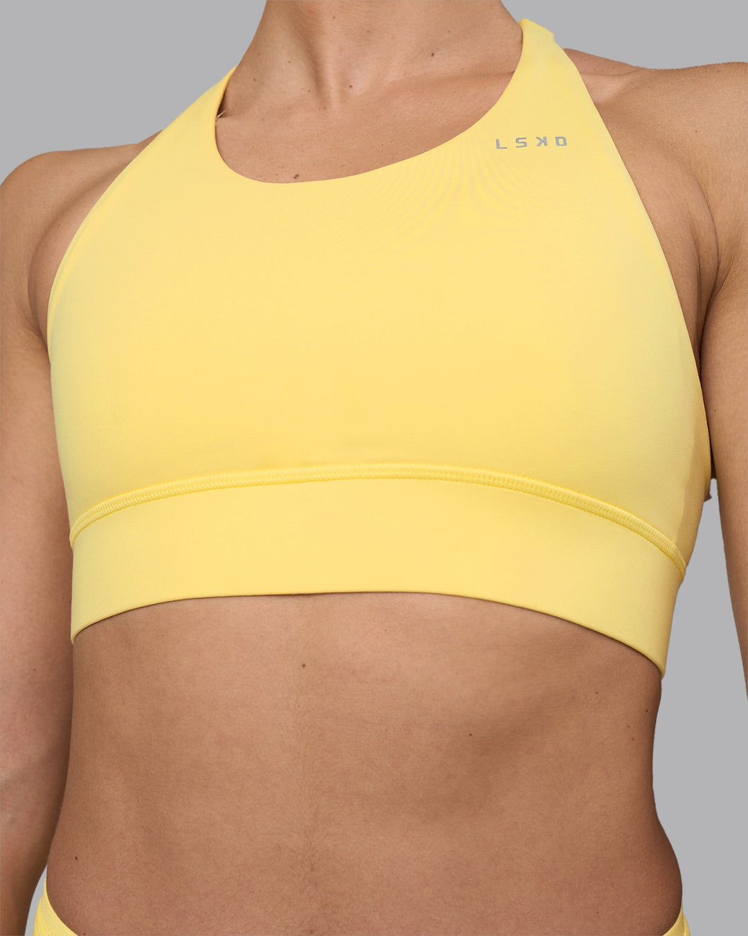 Woman wearing Accelerate Sports Bra - Lemon | Model:Sophie | Size:S