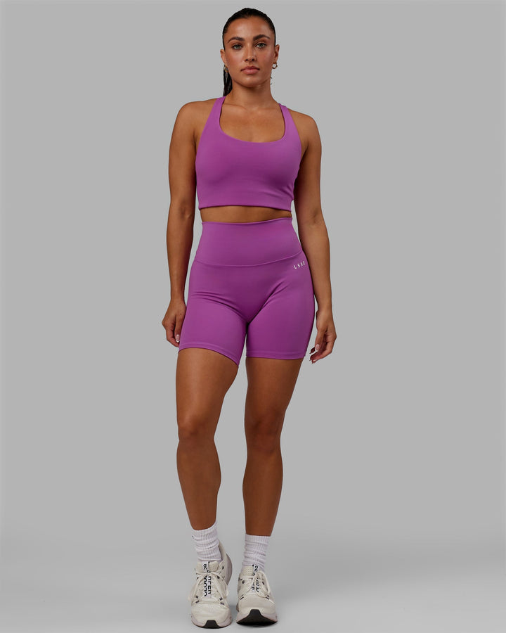 Woman wearing Base 2.0 Mid-Length Shorts - Hyper Violet